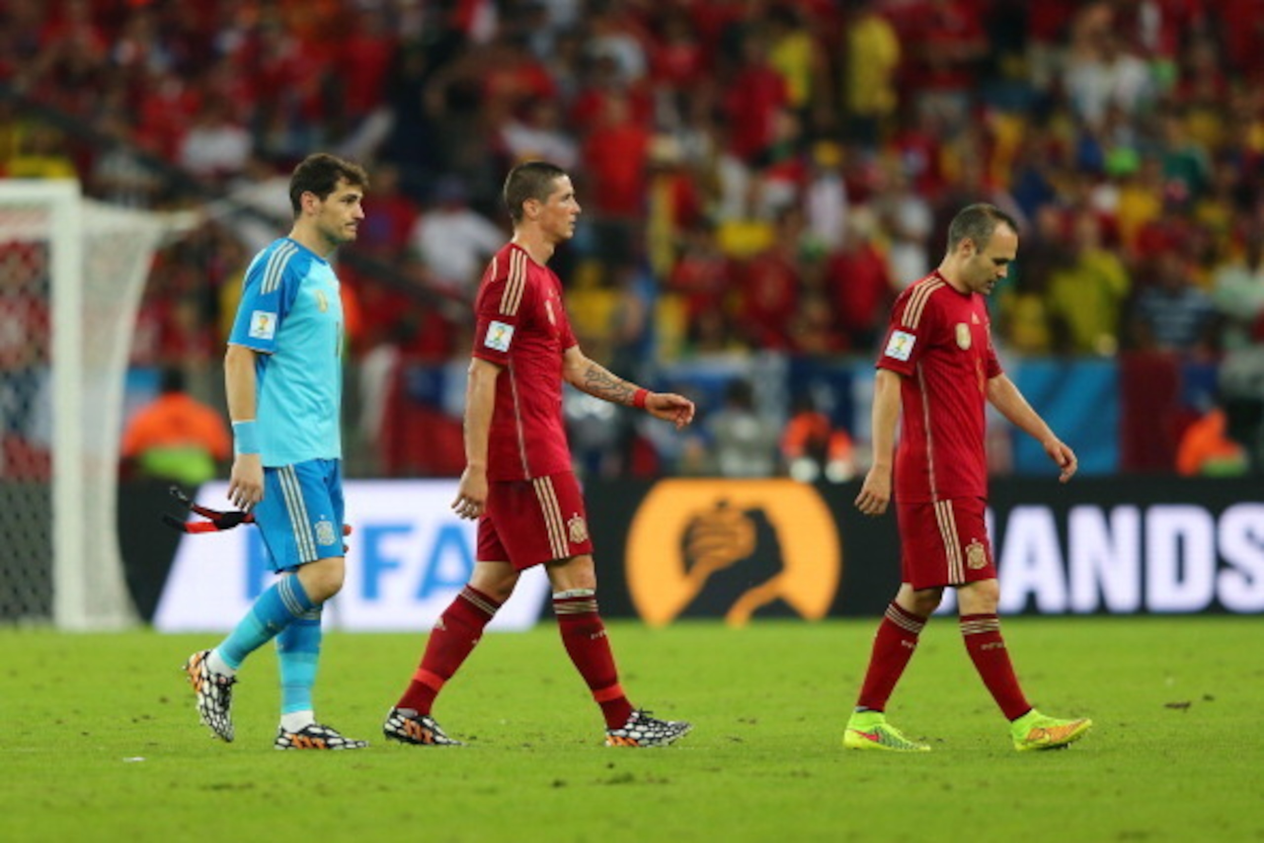 RIO DE JANEIRO, BRAZIL - JUNE 18:  (L-R) A dejected Iker Casillas, Fernando Torres and Andres Iniesta of Spain looks on after being defeated by Chile 2-0 during the 2014 FIFA World Cup Brazil Group B match between Spain and Chile at Maracana on June 18, 2