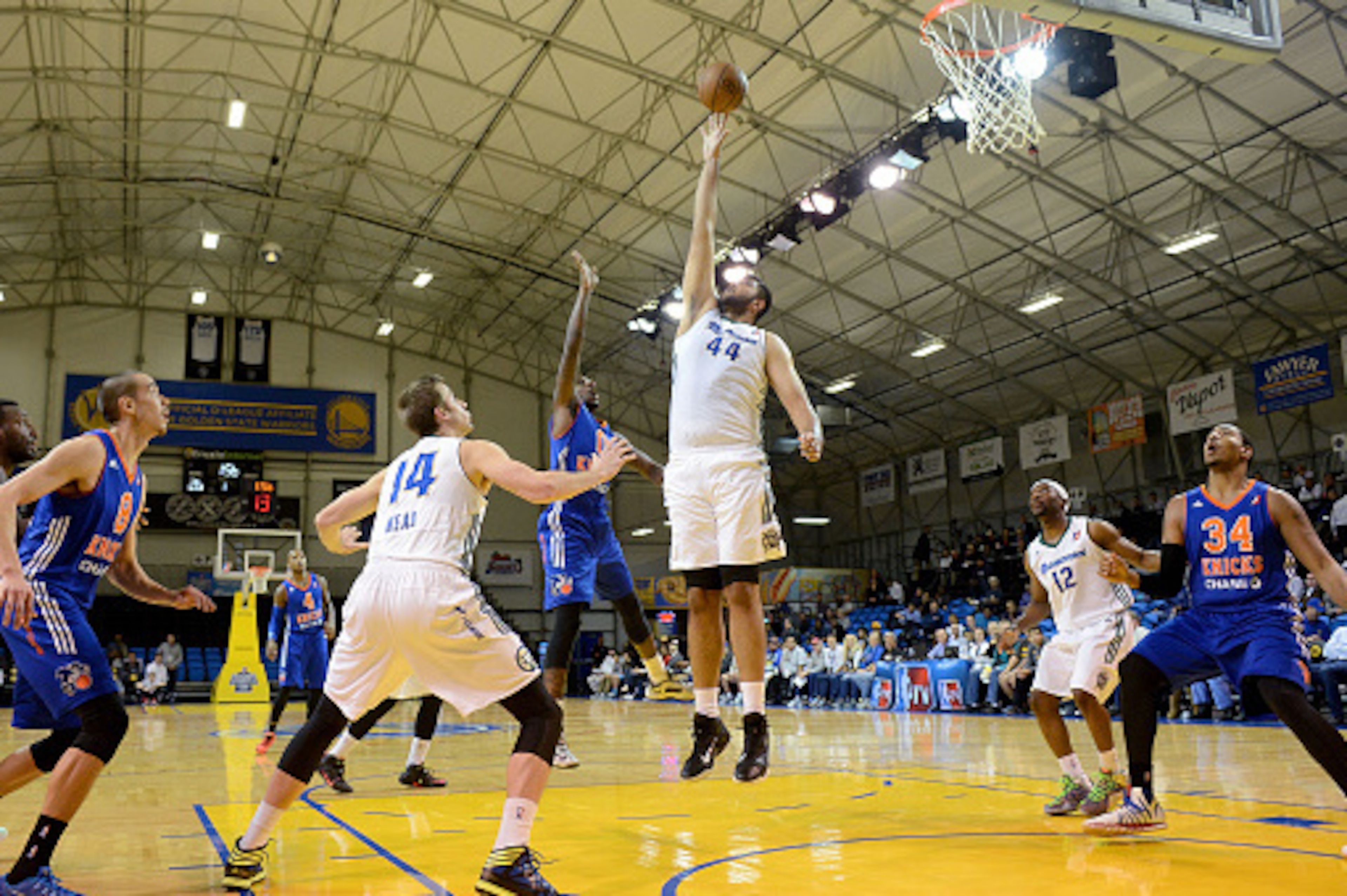 SANTA CRUZ, CA - JANUARY 16:   Walker Russell #0 of the Westchester Knicks puts up a shot over Sim Bhullar #44 of the Reno Bighorns during the 2015 NBA D-League Showcase presented by Samsung at the Kaiser Permanente Arena on January 16, 2015 in Santa Cruz