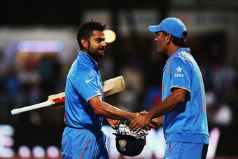 HAMILTON, NEW ZEALAND - MARCH 10:  Virat Kohli of India is congratulated by MS Dhoni of India after winning the 2015 ICC Cricket World Cup match between Ireland and India at Seddon Park on March 10, 2015 in Hamilton, New Zealand.  (Photo by Hannah Peters/