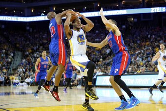 Mar 11, 2015; Oakland, CA, USA; Detroit Pistons guard Jodie Meeks (20) steals the ball against Golden State Warriors guard Andre Iguodala (9) while driving to the rim with Detroit Pistons forward Tayshaun Prince (22) during the fourth period at Oracle Are