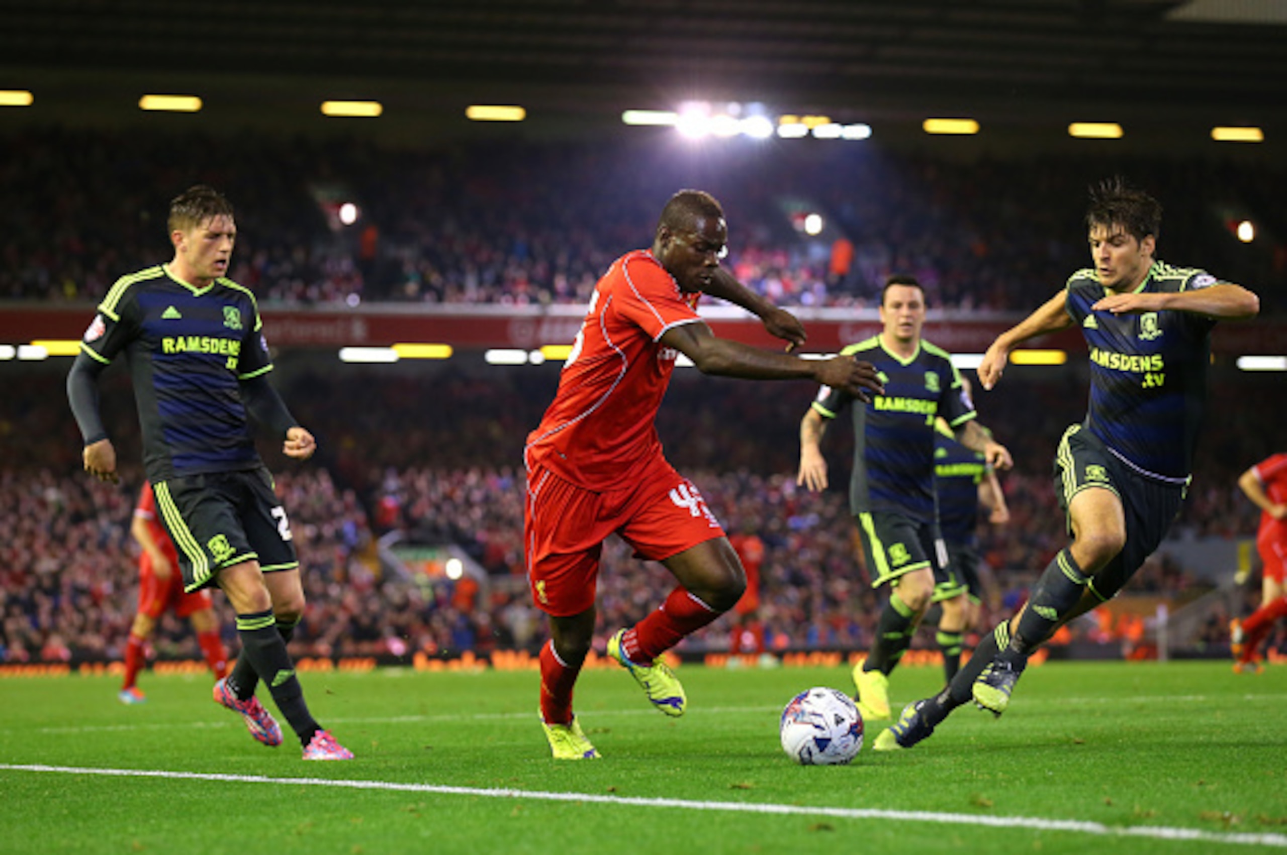 LIVERPOOL, ENGLAND - SEPTEMBER 23:  Mario Balotelli of Liverpool takes on George Friend of Middlesbrough during the Capital One Cup Third Round match between Liverpool and Middlesbrough at Anfield on September 23, 2014 in Liverpool, England.  (Photo by Al