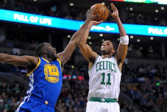 Mar 1, 2015; Boston, MA, USA; Boston Celtics guard Evan Turner (11) shoots the ball over Golden State Warriors forward Draymond Green (23) during the first half at TD Garden. Mandatory Credit: Bob DeChiara-USA TODAY Sports
