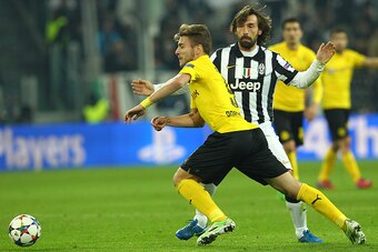TURIN, ITALY - FEBRUARY 24:  Ciro Immobile of Borussia Dortmund competes for the ball with Andrea Pirlo of Juventus FC during the UEFA Champions League Round of 16 match between Juventus and Borussia Dortmund at Juventus Arena on February 24, 2015 in Turi