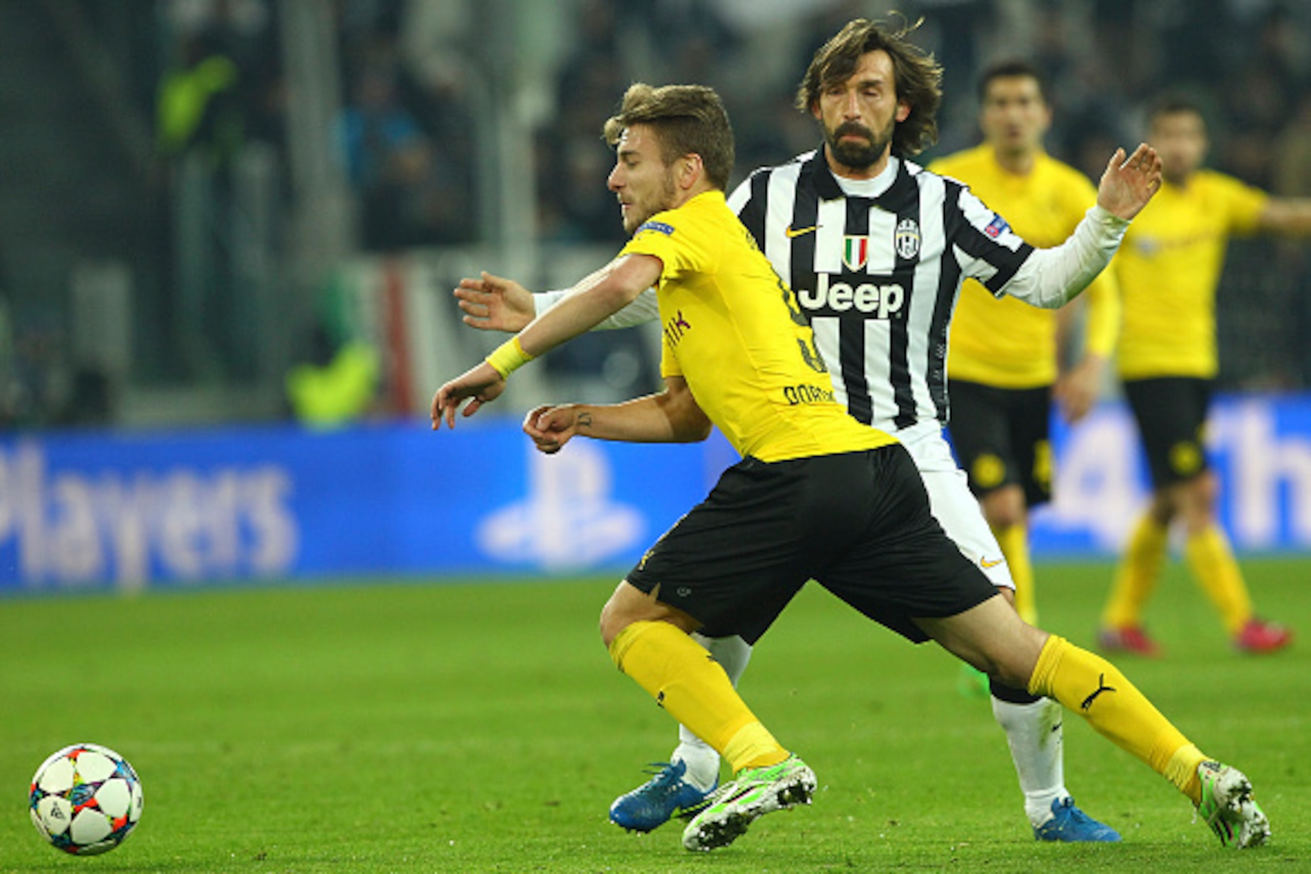 TURIN, ITALY - FEBRUARY 24:  Ciro Immobile of Borussia Dortmund competes for the ball with Andrea Pirlo of Juventus FC during the UEFA Champions League Round of 16 match between Juventus and Borussia Dortmund at Juventus Arena on February 24, 2015 in Turi