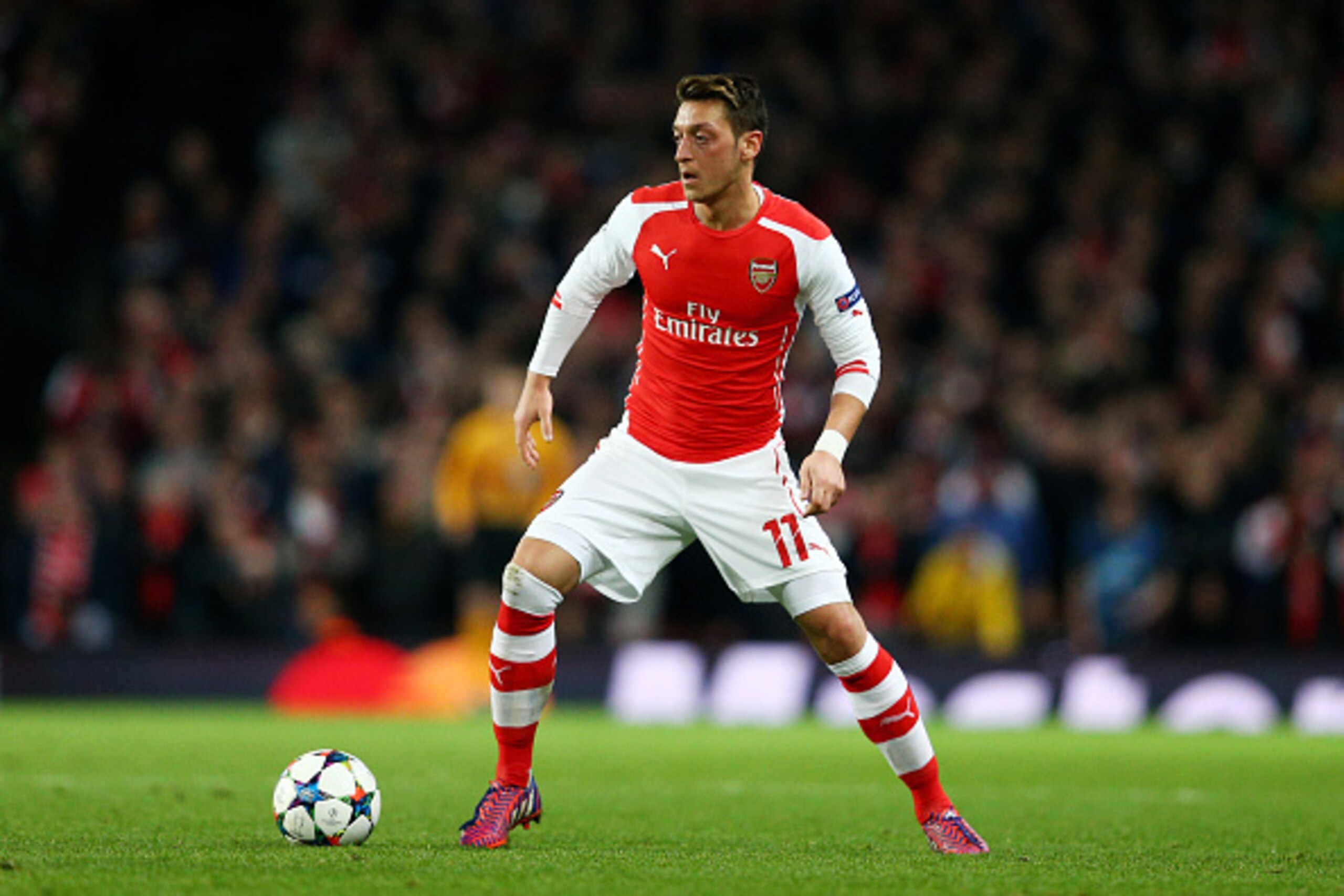 LONDON, ENGLAND - FEBRUARY 25:  Mesut Oezil of Arsenal runs with the ball during the UEFA Champions League round of 16, first leg match between Arsenal and Monaco at The Emirates Stadium on February 25, 2015 in London, United Kingdom.  (Photo by Clive Mas