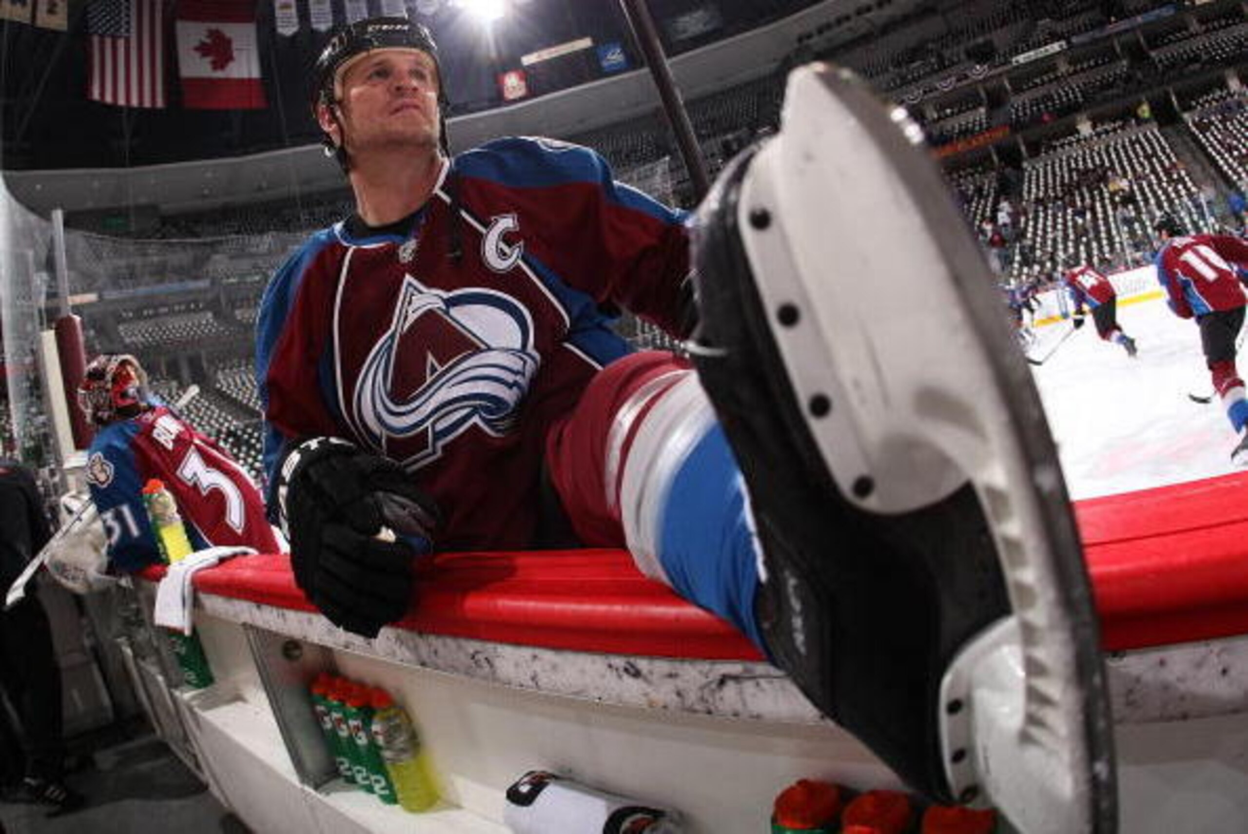 DENVER - APRIL 20:  Adam Foote #52 of the Colorado Avalanche stretches during warm-ups before the start of Game Four of the Western Conference Quarterfinals against the San Jose Sharks during the 2010 NHL Stanley Cup Playoffs at the Pepsi Center on April 