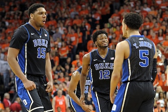 CHARLOTTESVILLE, VA - JANUARY 31: Jahlil Okafor #15, Justise Winslow #12 and Tyus Jones #5 of the Duke Blue Devils celebrate following a late-three pointer by Jones against the Virginia Cavaliers at John Paul Jones Arena on January 31, 2015 in Charlottesv