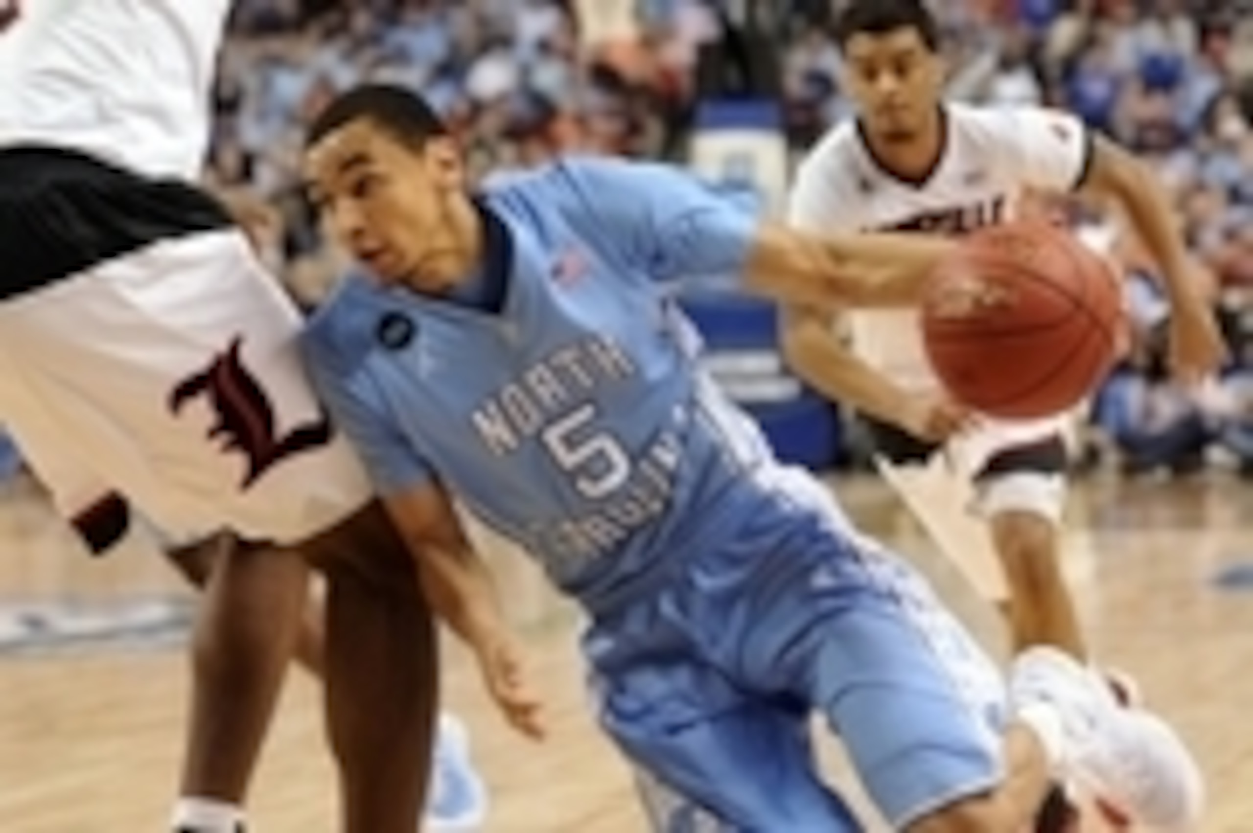 Mar 12, 2015; Greensboro, NC, USA; North Carolina Tar Heels guard Marcus Paige (5) drives past Louisville Cardinals forward/center Chinanu Onuaku (32) in the first half during the quarterfinals of the ACC Tournament at Greensboro Coliseum. Mandatory Credi