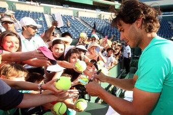 INDIAN WELLS, CA - MARCH 17:  Rafael Nadal of Spain signs autographs after defeating Juan Martin Del Potro of Argentina to win the men's final match of the 2013 BNP Paribas Open at the Indian Wells Tennis Garden on March 17, 2013 in Indian Wells, Californ
