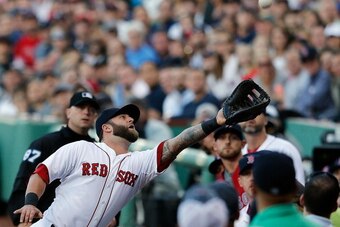 BOSTON, MA - MAY 17:  Mike Napoli #12 of the Boston Red Sox makes a catch on a foul ball against the Detroit Tigers in the first inning at Fenway Park on May 17, 2014 in Boston, Massachusetts.  (Photo by Jim Rogash/Getty Images)
