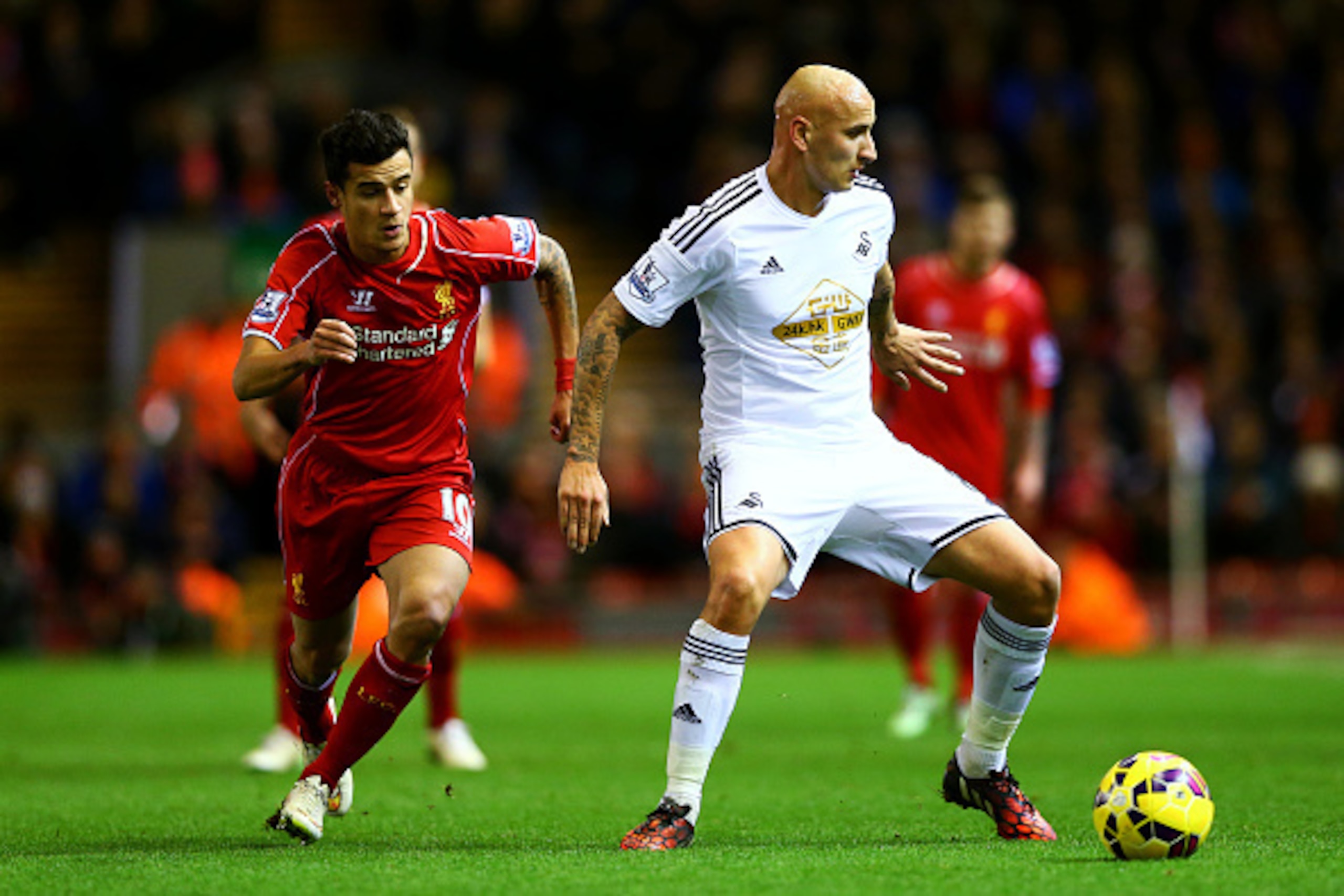 LIVERPOOL, ENGLAND - DECEMBER 29: Jonjo Shelvey of Swansea City passes the ball under pressure from Philippe Coutinho of Liverpool during the Barclays Premier League match between Liverpool and Swansea City at Anfield on December 29, 2014 in Liverpool, E LIVERPOOL, ENGLAND - DECEMBER 29: Jonjo Shelvey of Swansea City passes the ball under pressure from Philippe Coutinho of Liverpool during the Barclays Premier League match between Liverpool and Swansea City at Anfield on December 29, 2014 in Liverpool, E