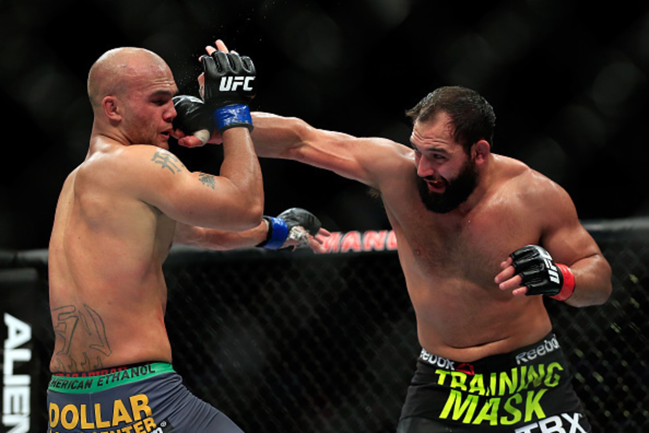 LAS VEGAS, NV - DECEMBER 06:  Johny Hendricks punches Robbie Lawler in their welterweight title fight during the UFC 181 event at the Mandalay Bay Events Center on December 6, 2014 in Las Vegas, Nevada.  (Photo by Alex Trautwig/Getty Images)
