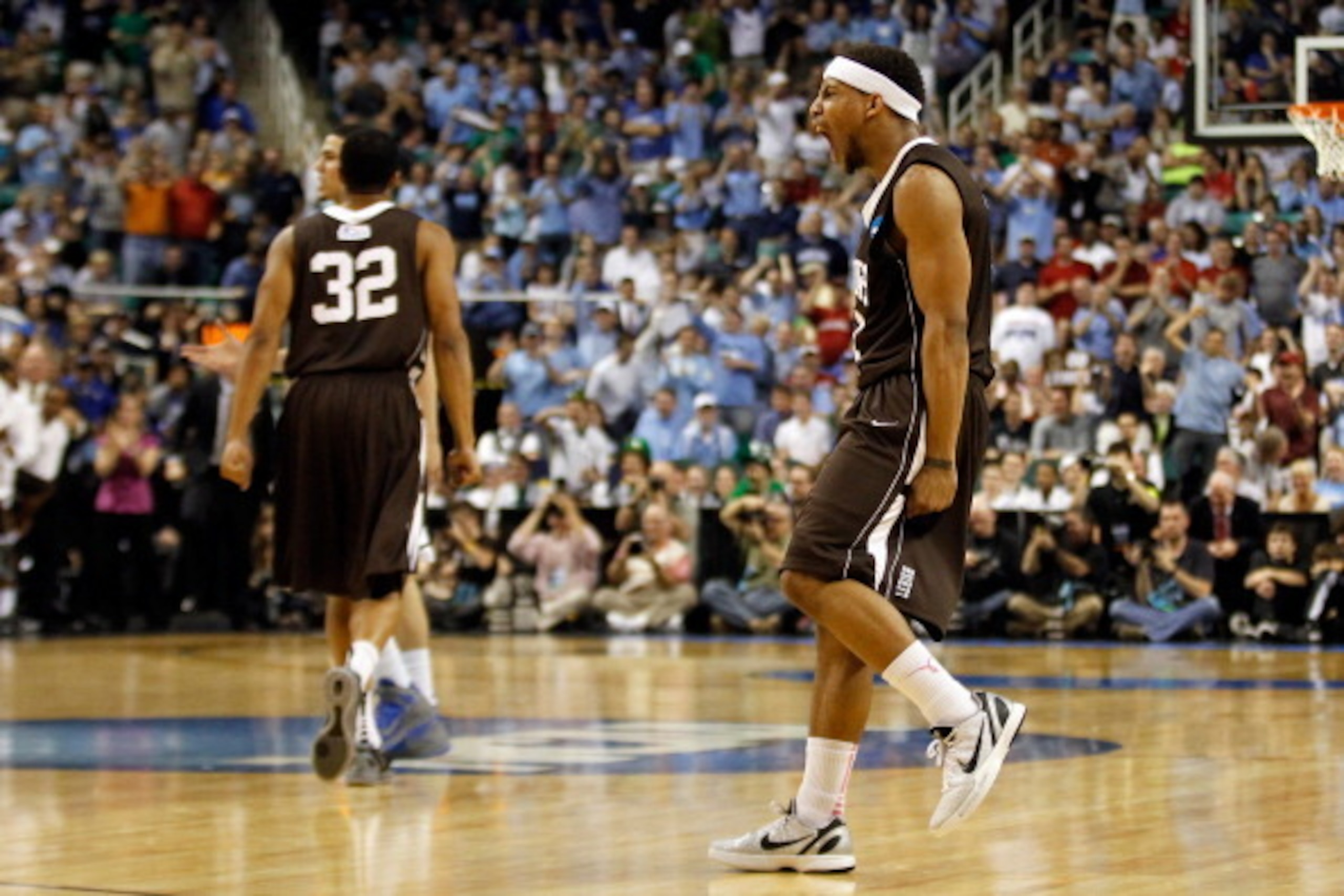 GREENSBORO, NC - MARCH 16:  (R) Mackey McKnight #11 of the Lehigh Mountain Hawks reacts late in the second half before the Mountain Hawks defeat the Duke Blue Devils 75-70 during the second round of the 2012 NCAA Men's Basketball Tournament at Greensboro 