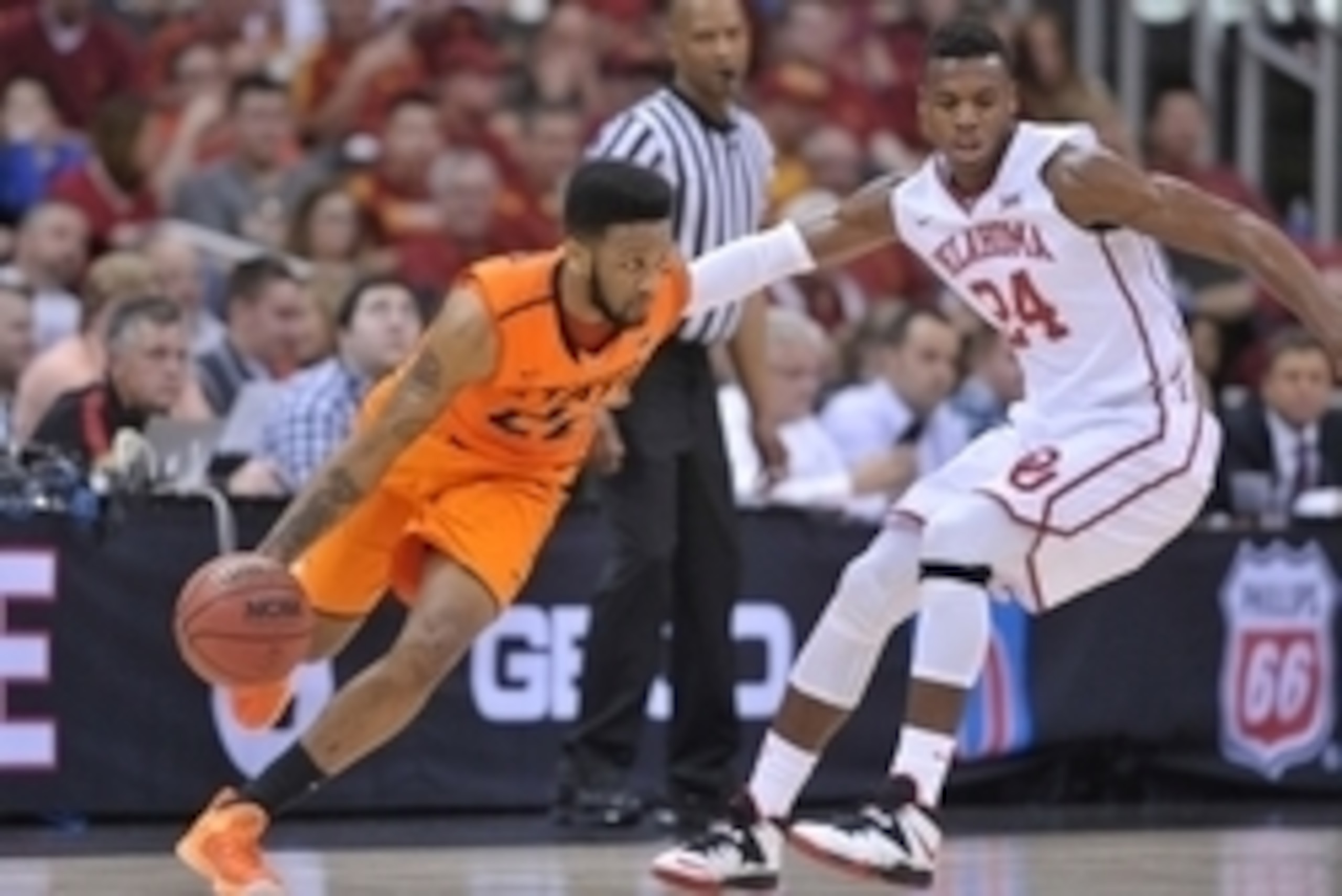 Mar 12, 2015; Kansas City, MO, USA; Oklahoma State Cowboys guard Jeff Newberry (22) dribbles the ball as Oklahoma Sooners guard Buddy Hield (24) defends during the first round at Sprint Center. Mandatory Credit: Denny Medley-USA TODAY Sports