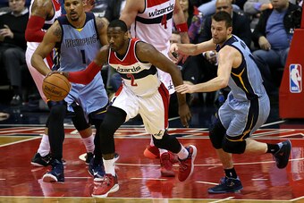 WASHINGTON, DC - MARCH 12: John Wall #2 of the Washington Wizards dribbles past Beno Udrih #19 of the Memphis Grizzlies in the second half at Verizon Center on March 12, 2015 in Washington, DC. NOTE TO USER: User expressly acknowledges and agrees that, by