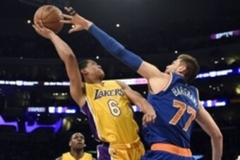 Mar 12, 2015; Los Angeles, CA, USA; Los Angeles Lakers guard Jordan Clarkson (6) attempts a shot against New York Knicks center Andrea Bargnani (77) in the second half during the game at Staples Center. Mandatory Credit: Richard Mackson-USA TODAY Sports