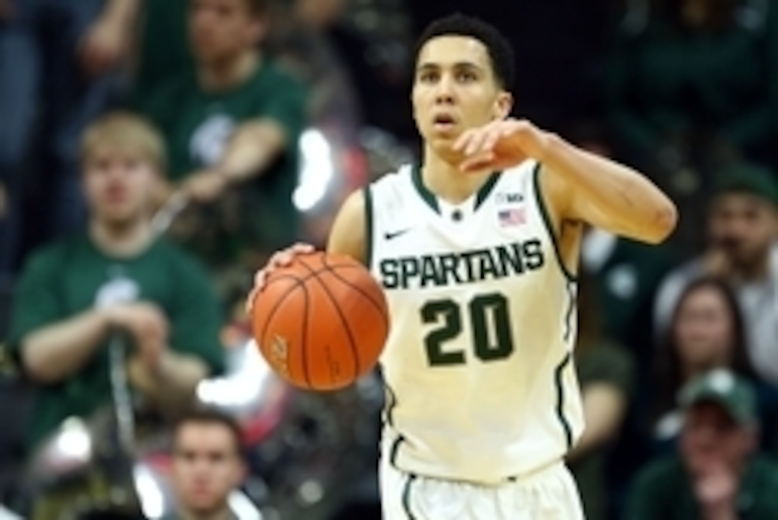 Mar 4, 2015; East Lansing, MI, USA; Michigan State Spartans guard Travis Trice (20) brings the ball up court against the Purdue Boilermakers during the 2nd half of a game at Jack Breslin Student Events Center. Mandatory Credit: Mike Carter-USA TODAY Sport