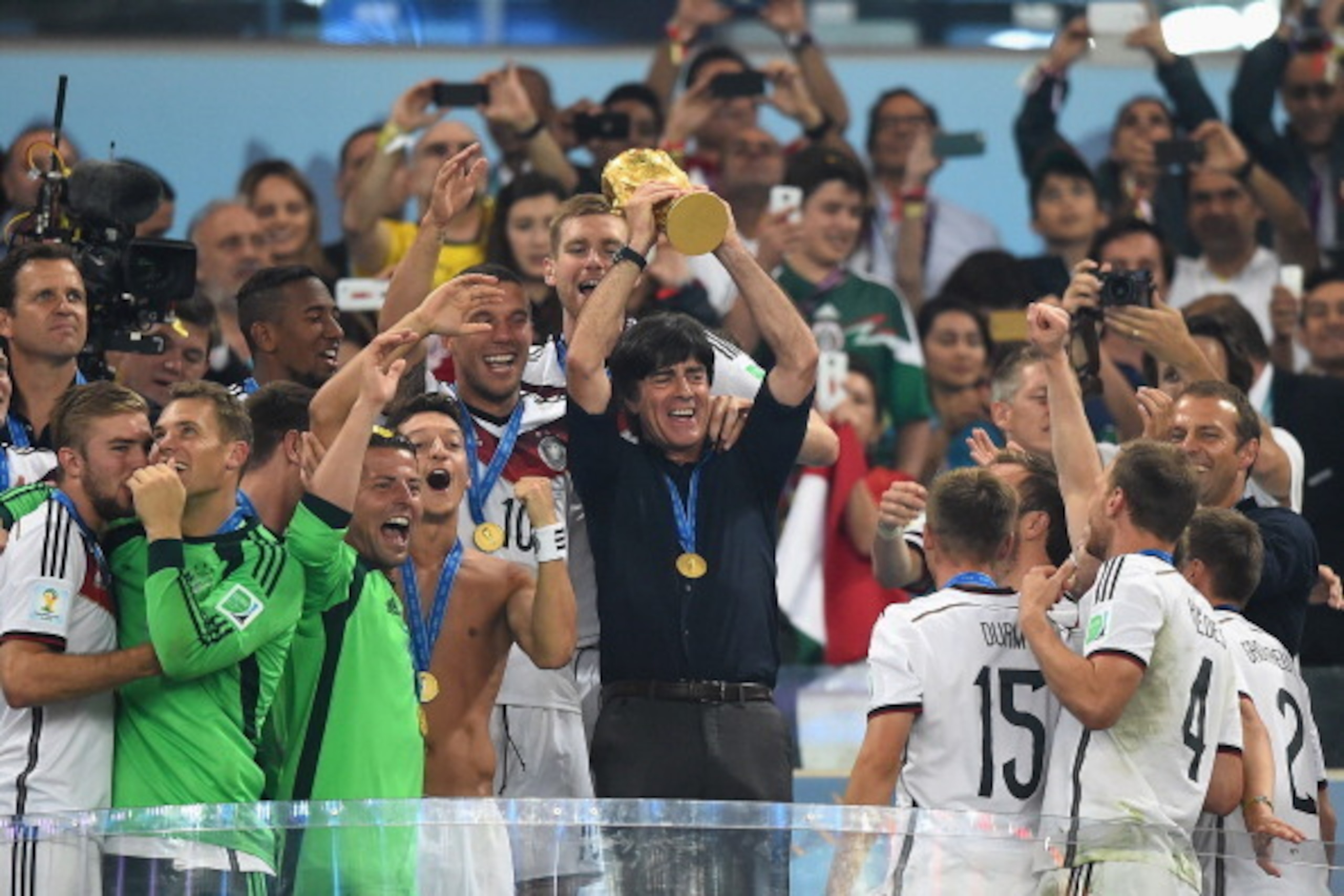 RIO DE JANEIRO, BRAZIL - JULY 13:  Joachim Loew of Germany lifts the World Cup trophy with his team after defeating Argentina 1-0 in extra time during the 2014 FIFA World Cup Brazil Final match between Germany and Argentinaat Maracana on July 13, 2014 in 