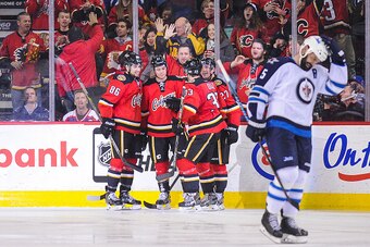 CALGARY, AB - FEBRUARY 2: Mason Raymond #21 (C) of the Calgary Flames celebrates with his teammates after scoring a goal against the Winnipeg Jets during an NHL game at Scotiabank Saddledome on February 2, 2015 in Calgary, Alberta, Canada. (Photo by Derek