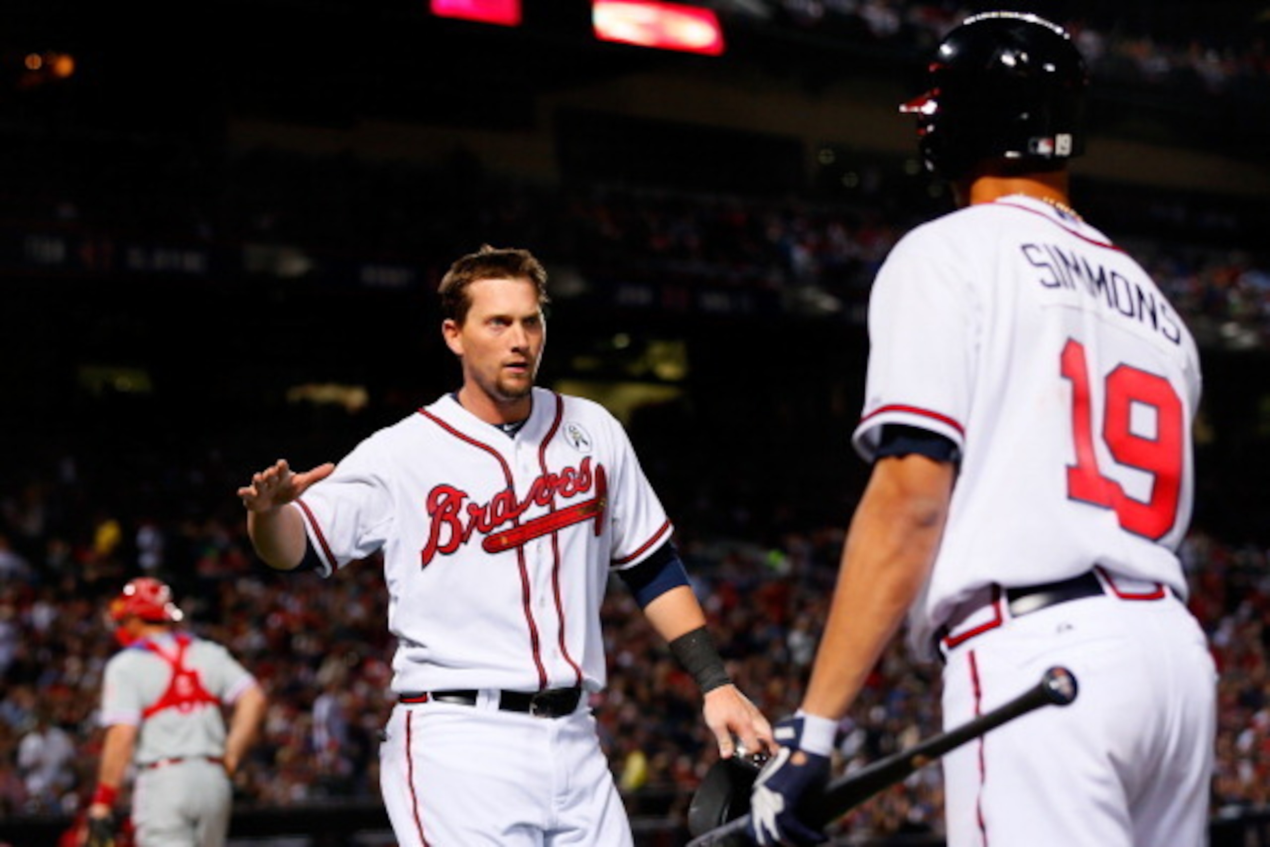 ATLANTA, GA - APRIL 01:  Chris Johnson #23 of the Atlanta Braves celebrates with Andrelton Simmons #19 after scoring on a double play ball in the sixth inning against the Philadelphia Phillies during Opening Day at Turner Field on April 1, 2013 in Atlanta