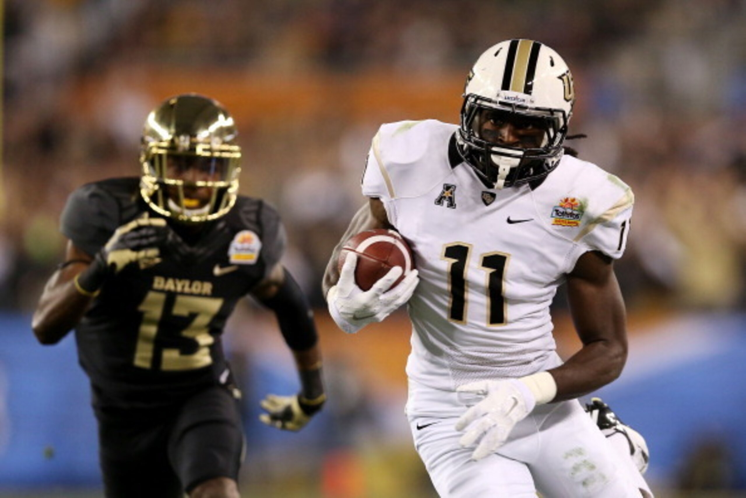 GLENDALE, AZ - JANUARY 01:  Breshad Perriman #11 of the UCF Knights completes a pass for 44 yards in the first quarter against the defense of Terrell Burt #13 of the Baylor Bears during the Tostitos Fiesta Bowl at University of Phoenix Stadium on January 