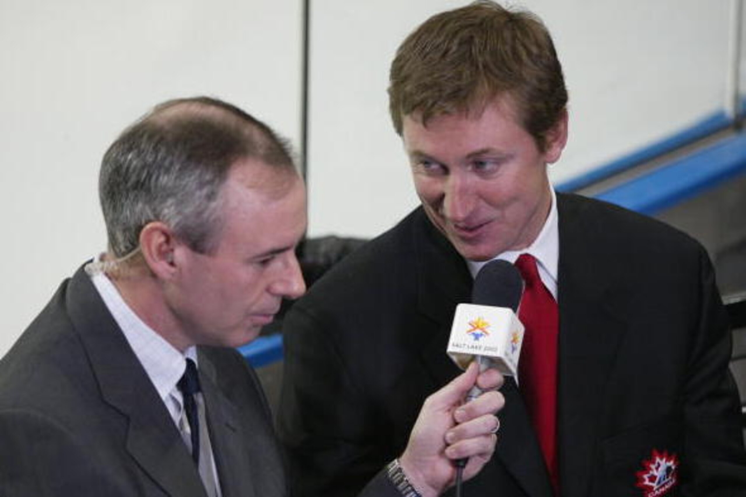 24 Feb 2002:  Executive director for Team Canada, Wayne Gretzky, talks with reporter Don McLean before the start of the USA versus Canada men's ice hockey gold medal game of the Salt Lake City Winter Olympic Games at the E Center in Salt Lake City, Utah. 