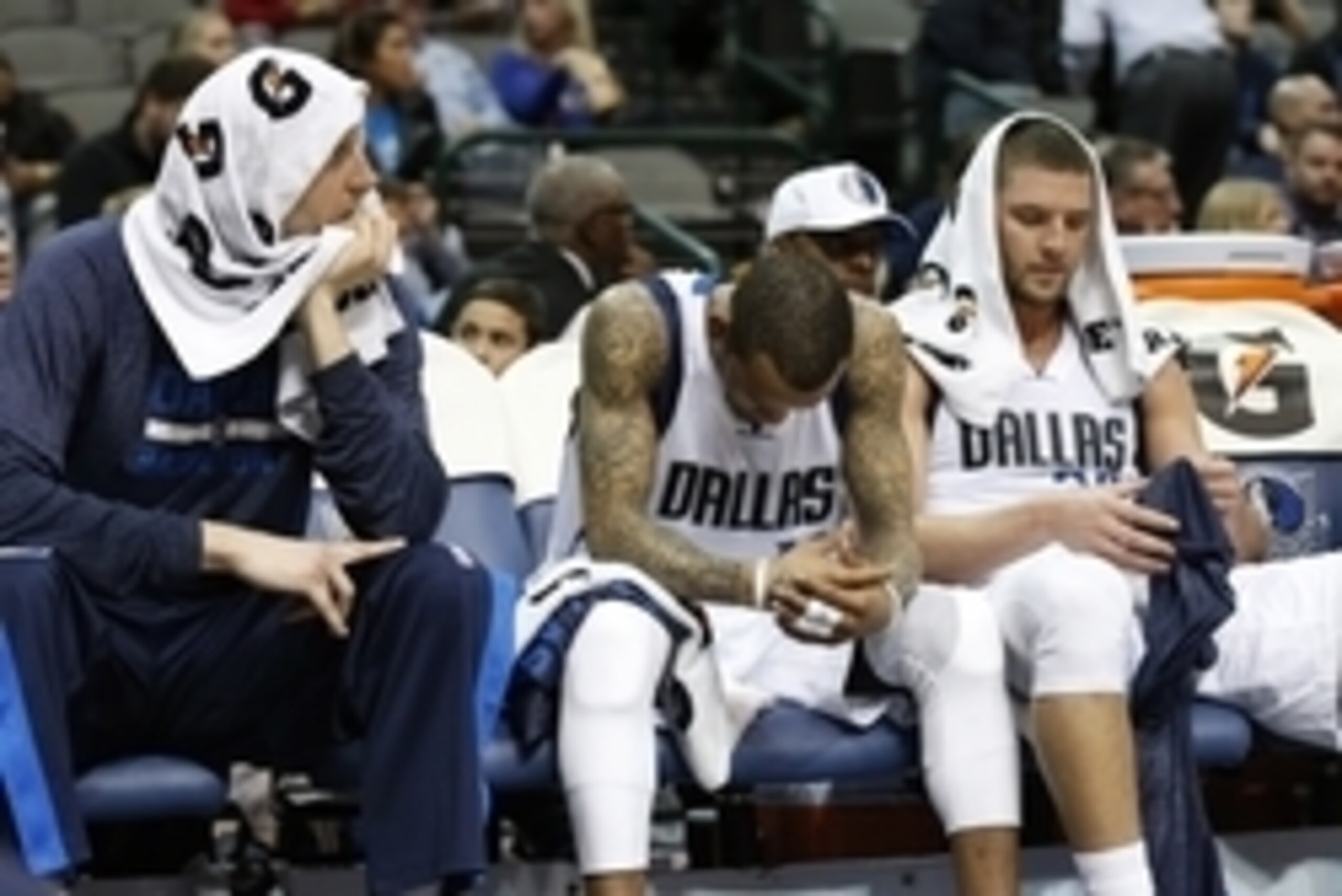 Mar 10, 2015; Dallas, TX, USA; Dallas Mavericks forward Dirk Nowitzki (41) guard Monta Ellis (11) and forward Chandler Parsons (25) sits on the bench in the fourth quarter against the Cleveland Cavaliers at American Airlines Center. The Cavs beat the Mavs