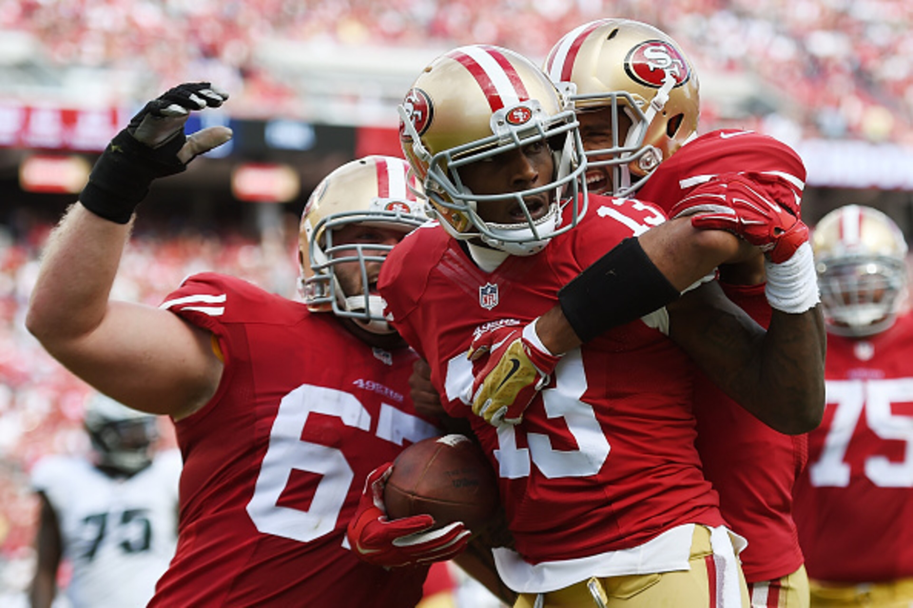 SANTA CLARA, CA - SEPTEMBER 28:  Stevie Johnson #13, Colin Kaepernick #7 and Daniel Kilgore #67 of the San Francisco 49ers celebrates after Johnson caught a touchdown pass against the Philadelphia Eagles during the third quarter at Levi's Stadium on Septe