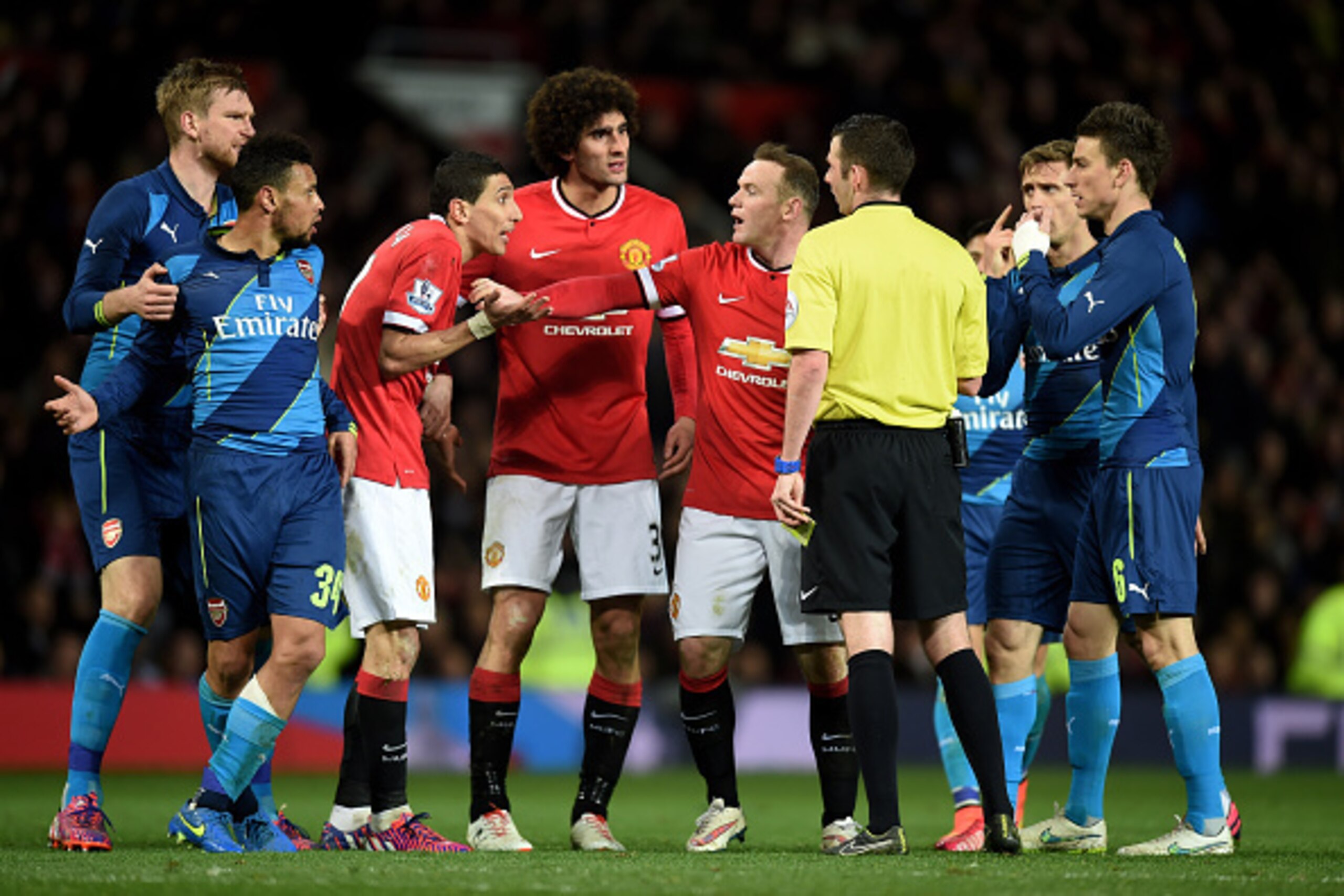 MANCHESTER, ENGLAND - MARCH 09:  Angel di Maria of Manchester United remonstrates with referee Michael Oliver as he receives the yellow card during the FA Cup Quarter Final match between Manchester United and Arsenal at Old Trafford on March 9, 2015 in Ma