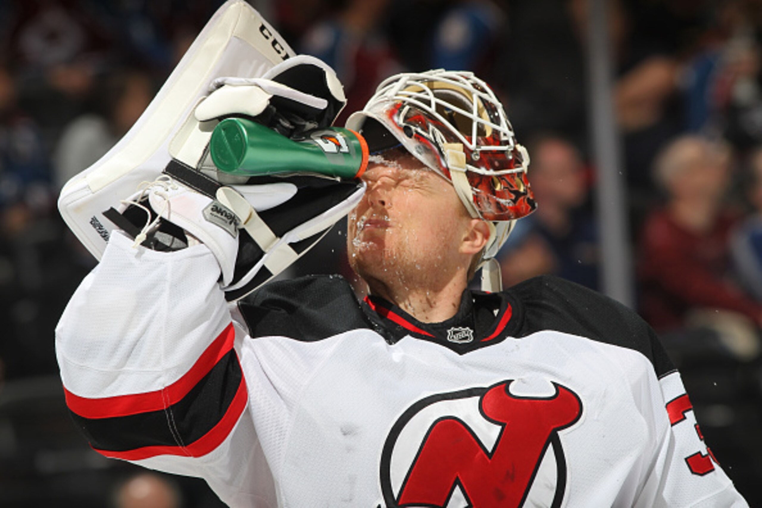 DENVER, CO - MARCH 12: Goaltender Cory Schneider #35 of the New Jersey Devils splashes his face with water during a break in the action against the Colorado Avalanche at the Pepsi Center on March 12, 2015 in Denver, Colorado.  (Photo by Michael Martin/NHL