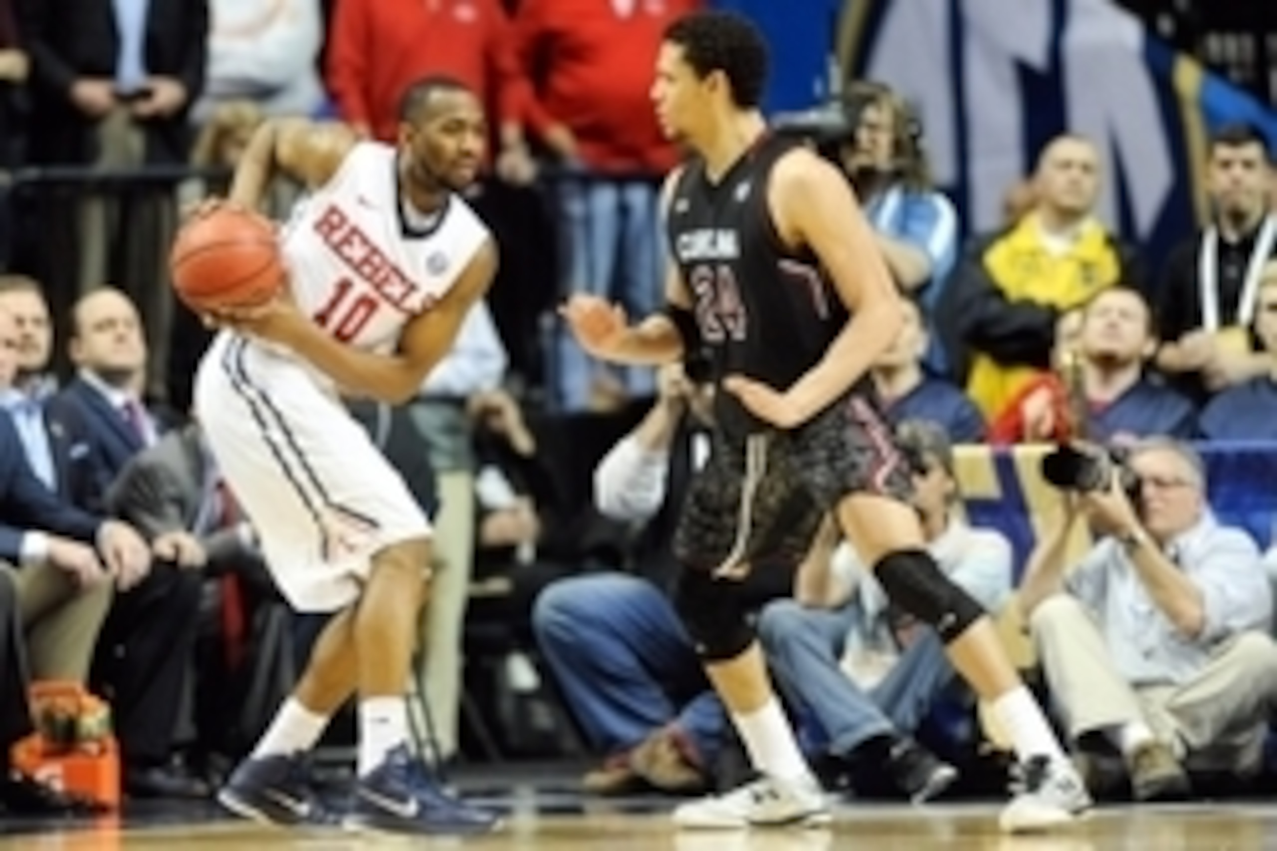 Mar 12, 2015; Nashville, TN, USA; Mississippi Rebels guard Ladarius White (10) keeps the ball away from South Carolina Gamecocks forward Michael Carrera (24) during the second half of the second round of the SEC Conference Tournament at Bridgestone Arena.