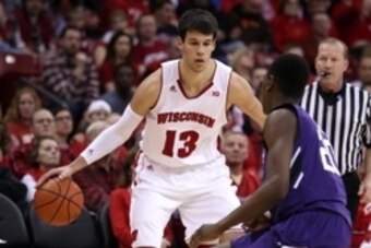Feb 7, 2015; Madison, WI, USA; Wisconsin Badgers forward Duje Dukan (13) looks to pass as Northwestern Wildcats guard Scottie Lindsey (20) defends at the Kohl Center. Wisconsin defeated Northwestern 65-50. Mandatory Credit: Mary Langenfeld-USA TODAY Sport