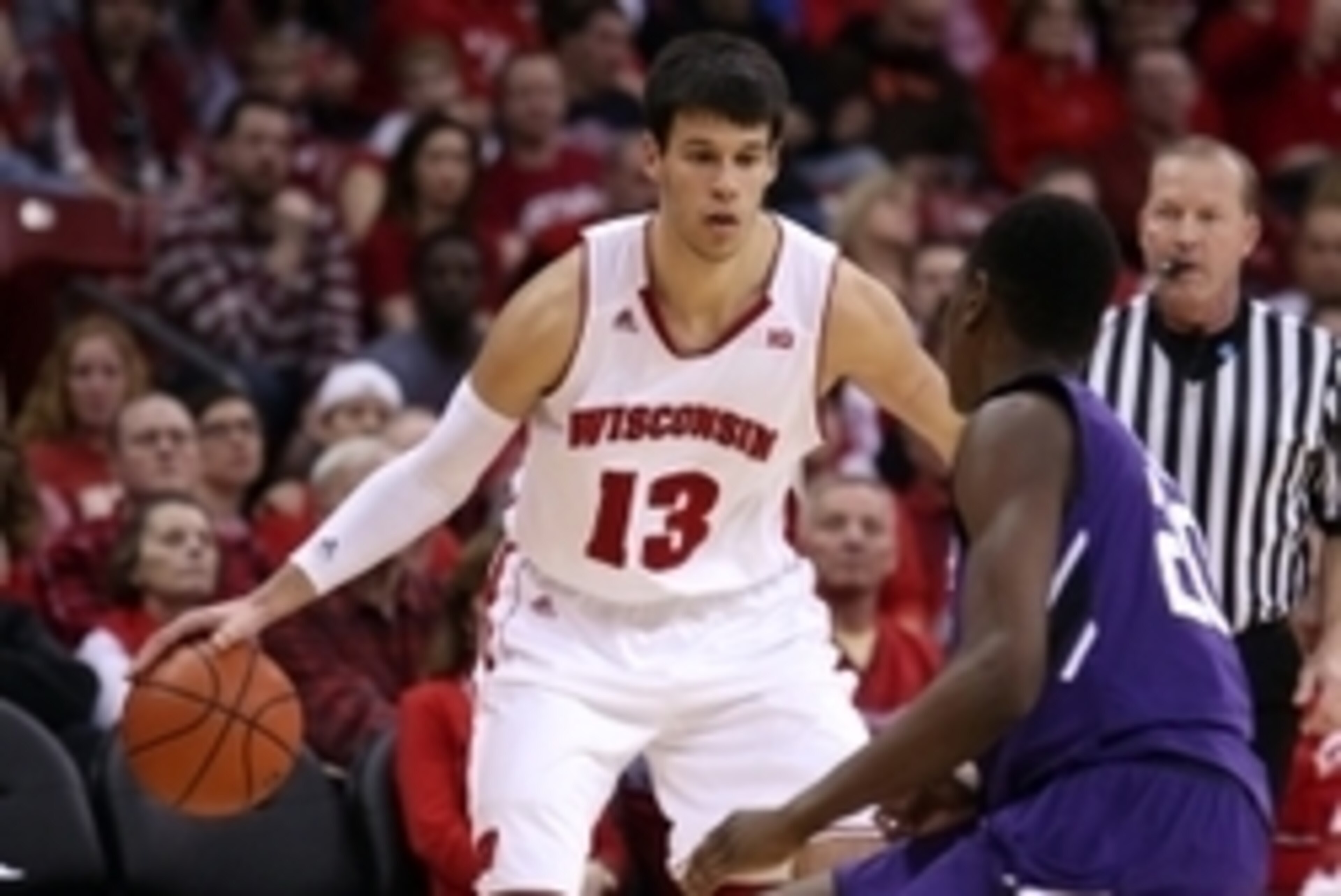 Feb 7, 2015; Madison, WI, USA; Wisconsin Badgers forward Duje Dukan (13) looks to pass as Northwestern Wildcats guard Scottie Lindsey (20) defends at the Kohl Center. Wisconsin defeated Northwestern 65-50. Mandatory Credit: Mary Langenfeld-USA TODAY Sport