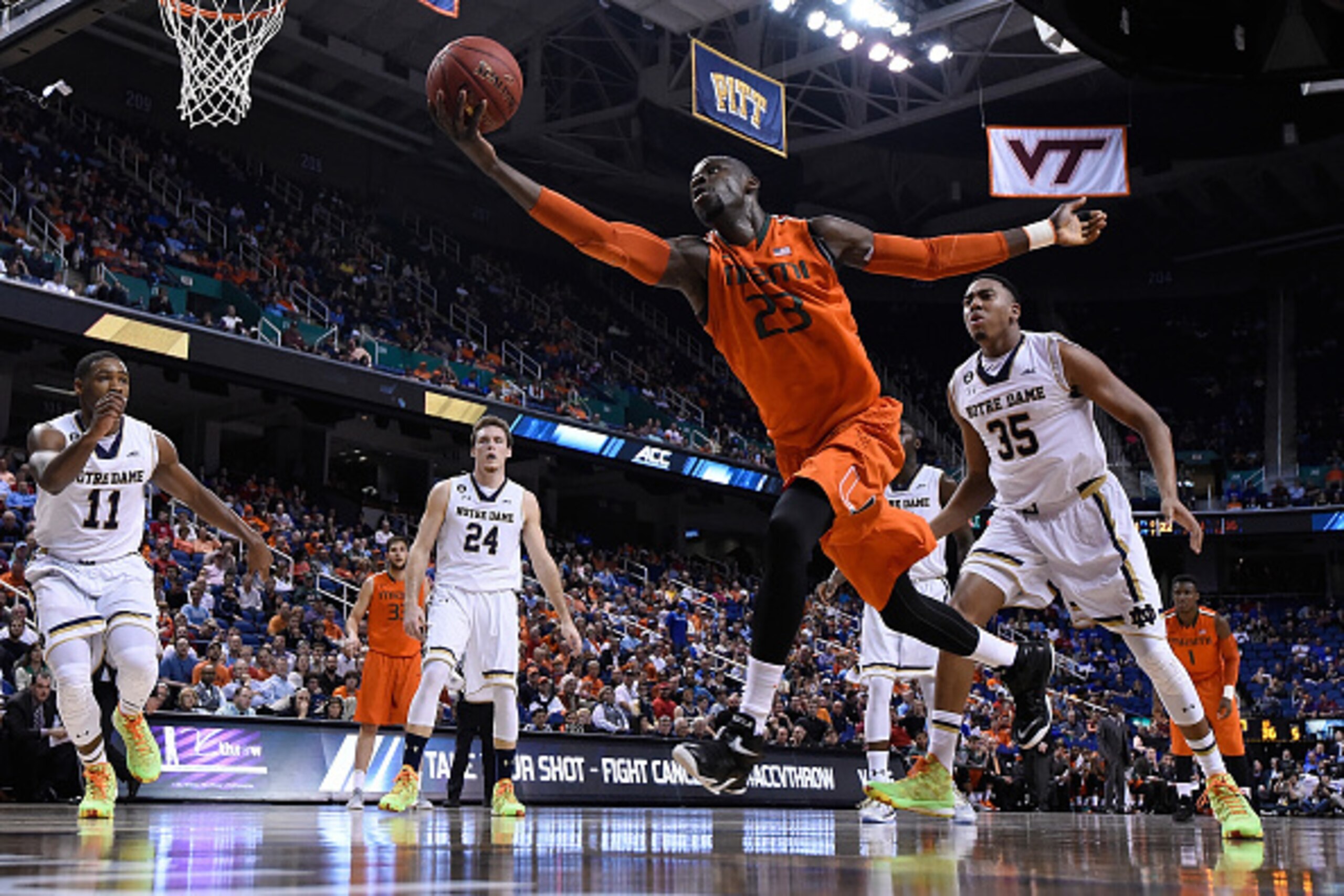 GREENSBORO, NC - MARCH 12:  Tonye Jekiri #23 of the Miami Hurricanes tracks down a loose ball on the end line against the Notre Dame Fighting Irish during the quarterfinals of the ACC Basketball Tournament at Greensboro Coliseum on March 12, 2015 in Green