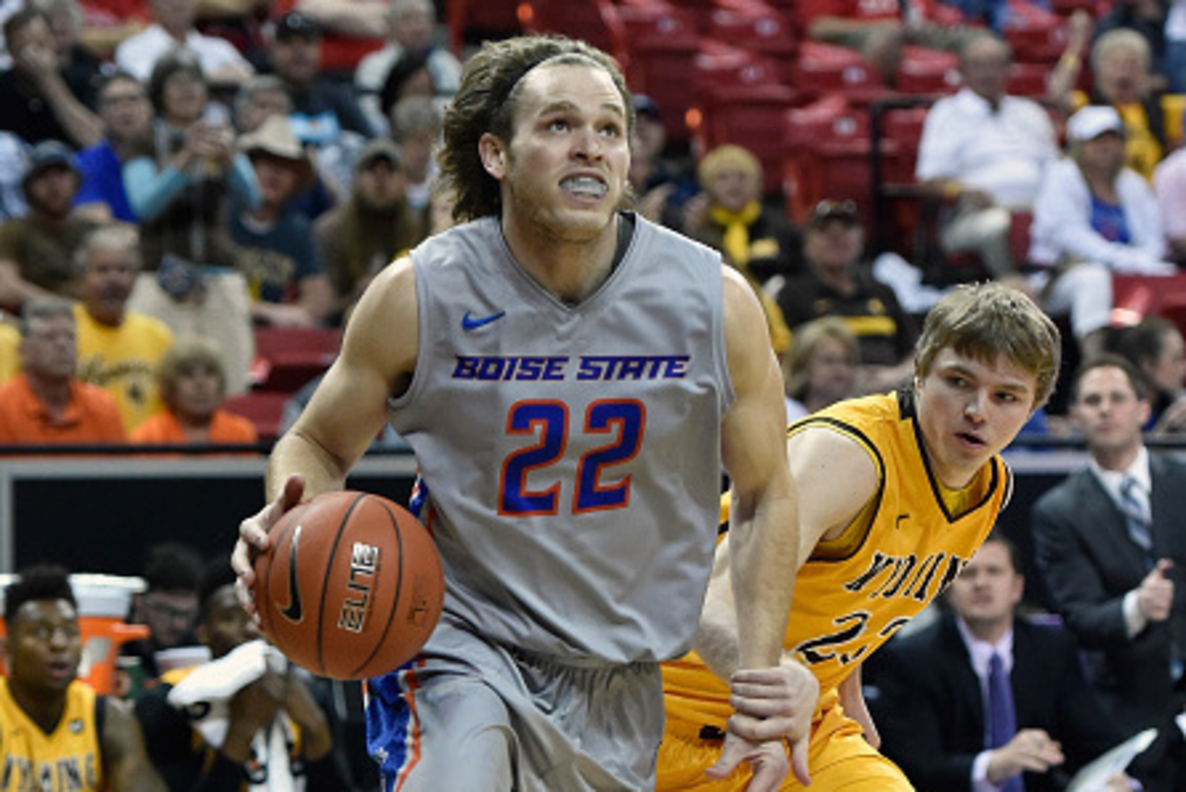 LAS VEGAS, NV - MARCH 13:  Rob Heyer #22 of the Boise State Broncos drives to the basket against Jason McManamen #23 of the Wyoming Cowboys during a semifinal game of the Mountain West Conference basketball tournament at the Thomas & Mack Center on March 