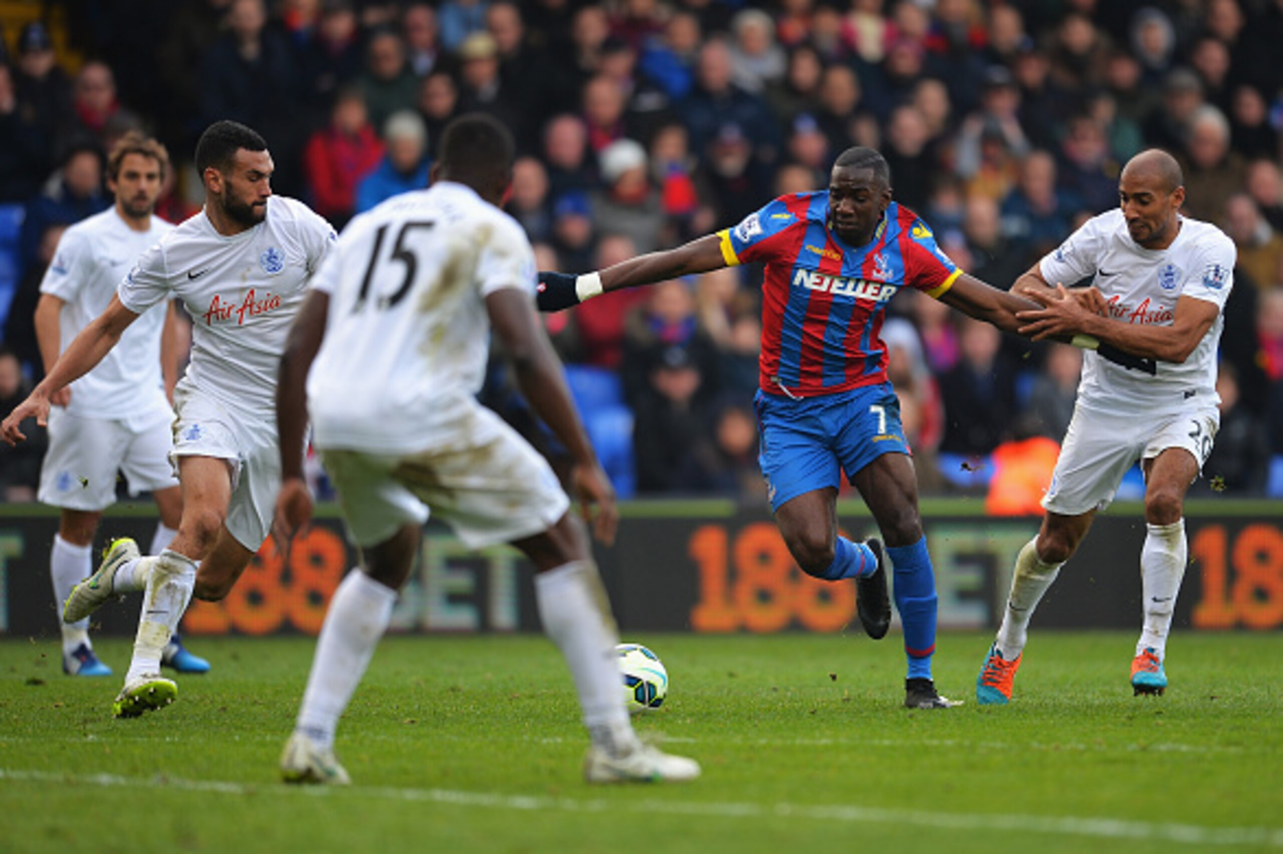 LONDON, ENGLAND - MARCH 14: Yannick Bolasie of Crystal Palace is held by Karl Henry of QPR during the Barclays Premier League match between Crystal Palace and Queens Park Rangers at Selhurst Park on March 14, 2015 in London, England.  (Photo by Christophe