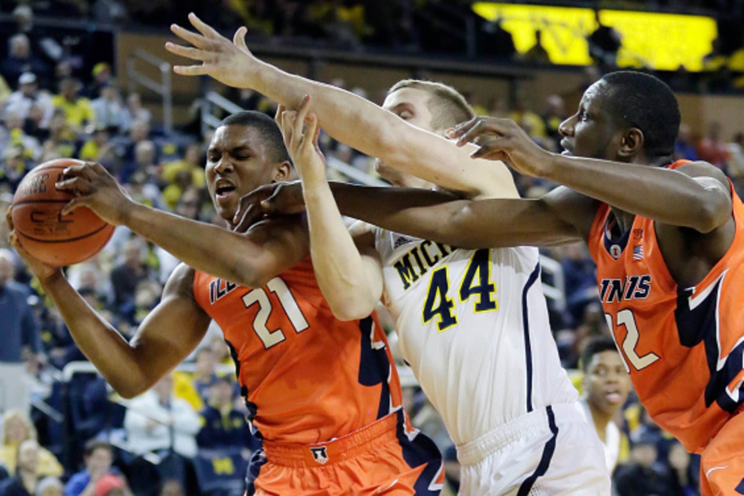 ANN ARBOR, MI - DECEMBER 30:  Malcolm Hill #21 of the Illinois Fighting Illini beats Max Bielfeldt #44 of the Michigan Wolverines to a rebound with the help of Nnanna Egwu #32 of the Illinois Fighting Illini during the first half at Crisler Arena on Decem