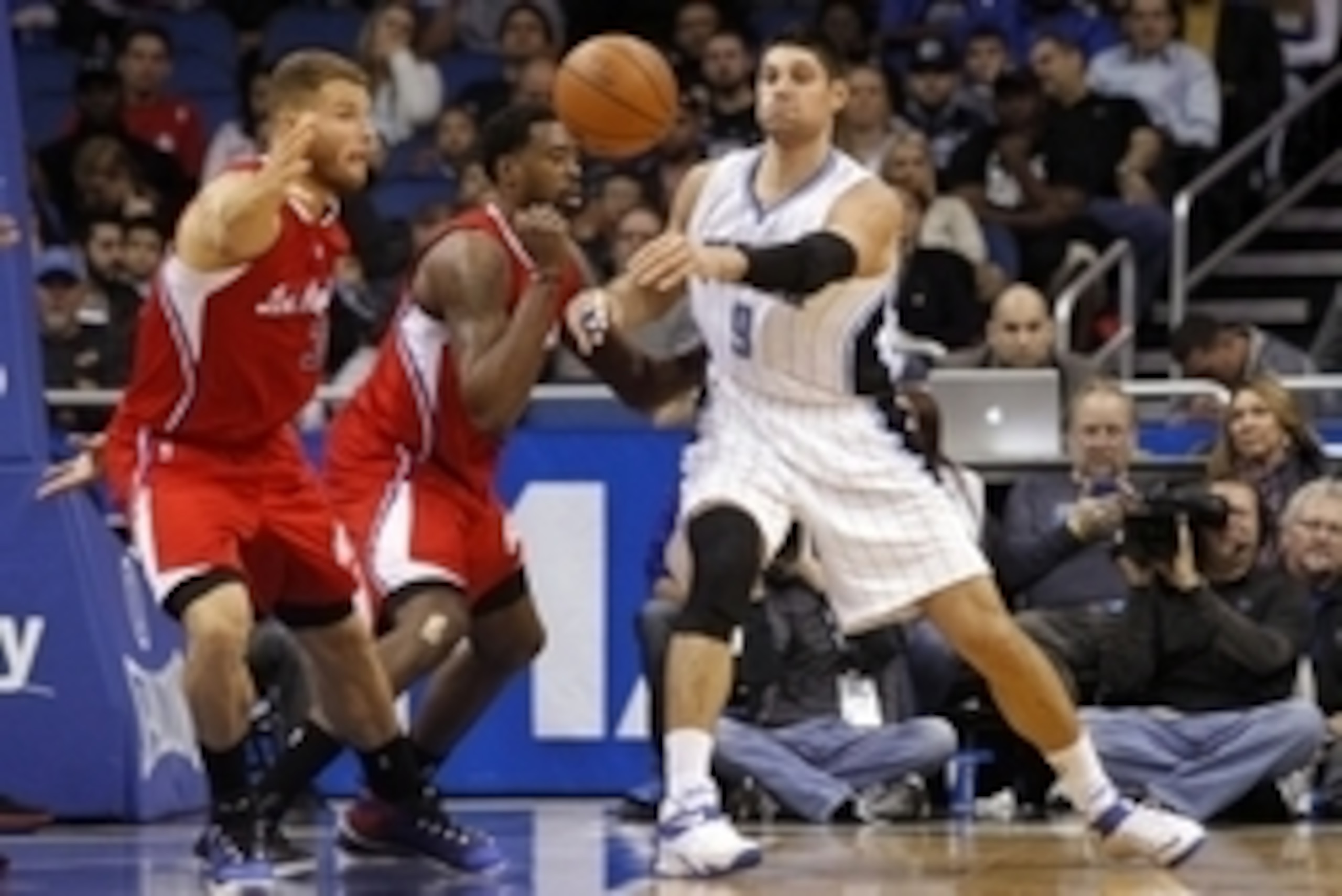 Nov 19, 2014; Orlando, FL, USA; Orlando Magic center Nikola Vucevic (9) passes the ball around Los Angeles Clippers center DeAndre Jordan (6) and forward Blake Griffin (32) during the second quarter at Amway Center. Mandatory Credit: Kim Klement-USA TODAY