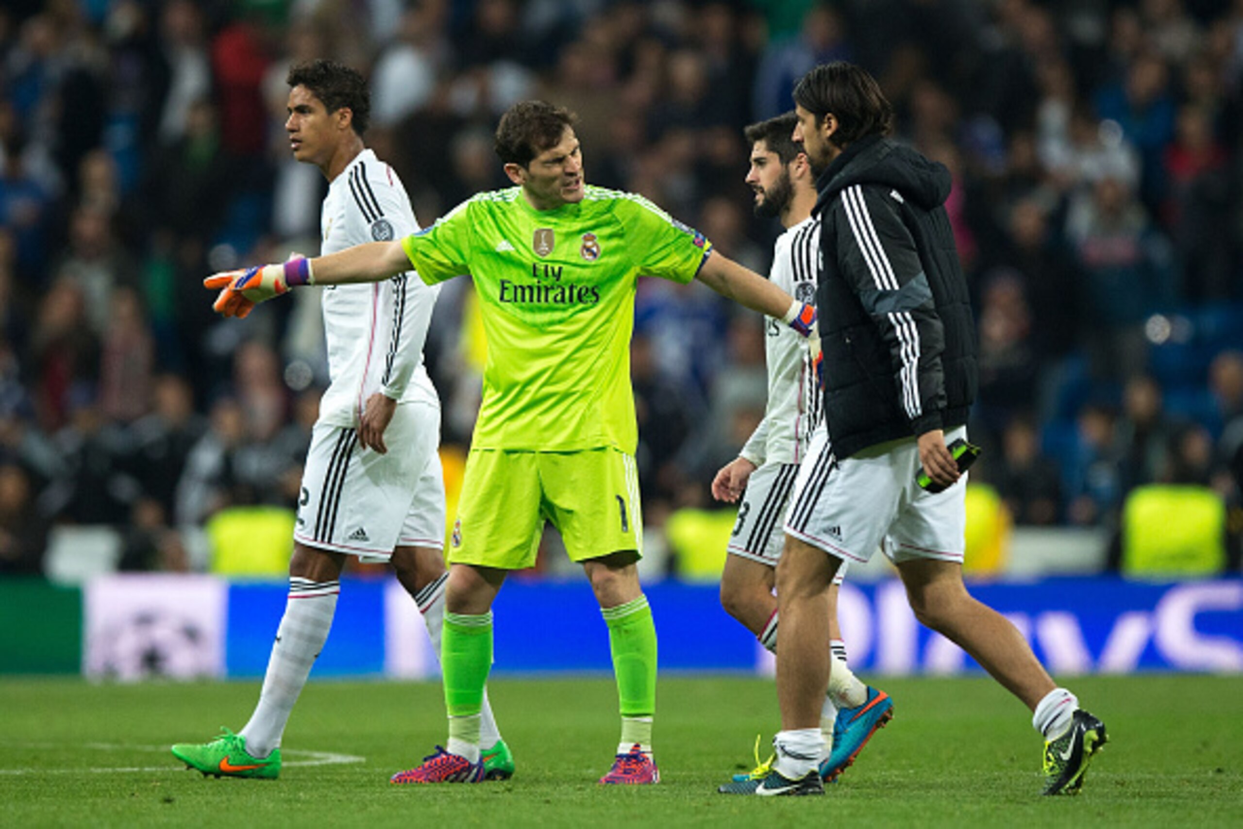 MADRID, SPAIN - MARCH 10:  goalkeeper Iker Casillas (2ndL) of Real Madrid CF holds his teammates Francisco Roman Alarcon alias Isco (2ndR) and Sami Khedira (R) in order to greets the audience close to Raphael Varane (L) after loosing the UEFA Champions Le