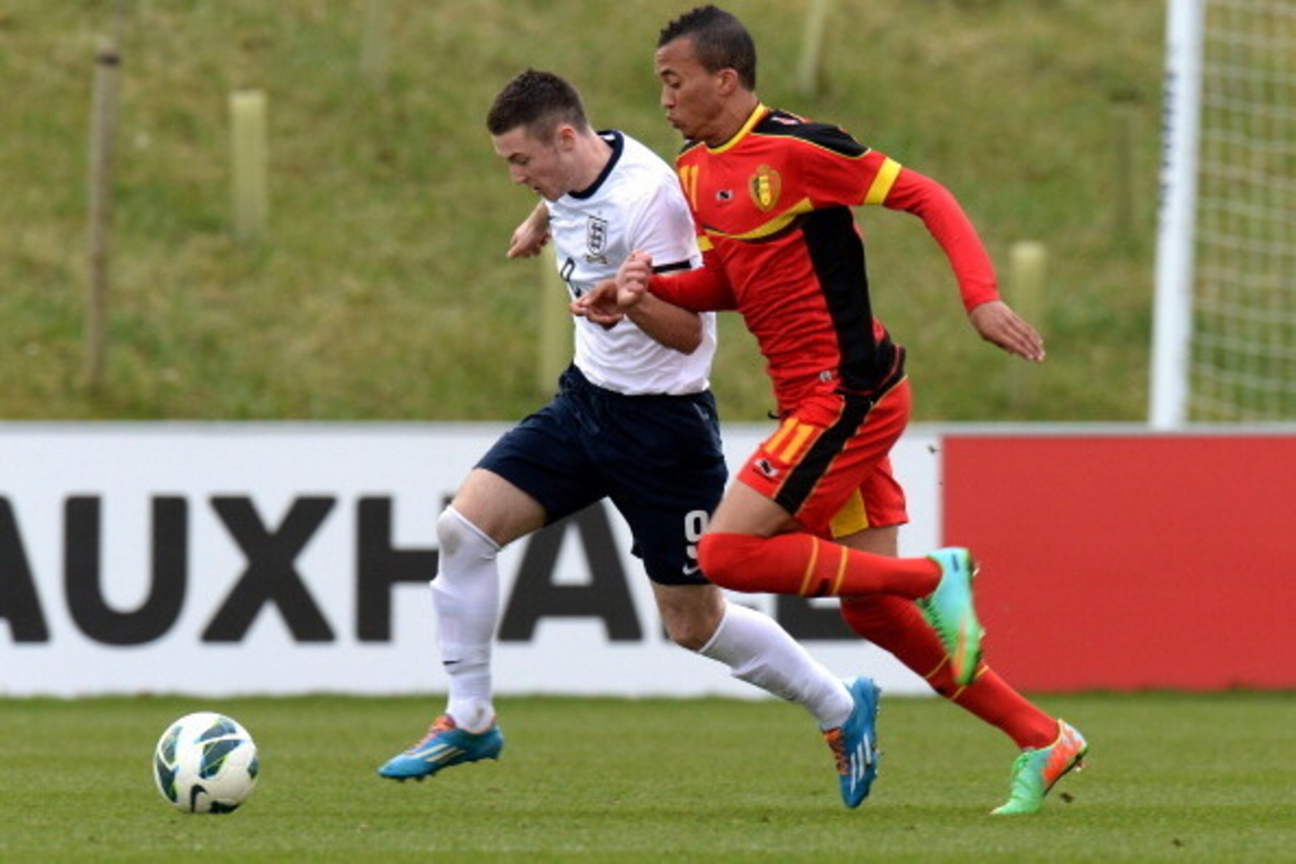 BURTON-UPON-TRENT, ENGLAND - FEBRUARY 18:  Bradley Fewster of England challenged by David Henen of Belgium during the U18 International Friendly match between England and Belgium at St Georges Park on February 18, 2014 in Burton-upon-Trent, England.  (Pho