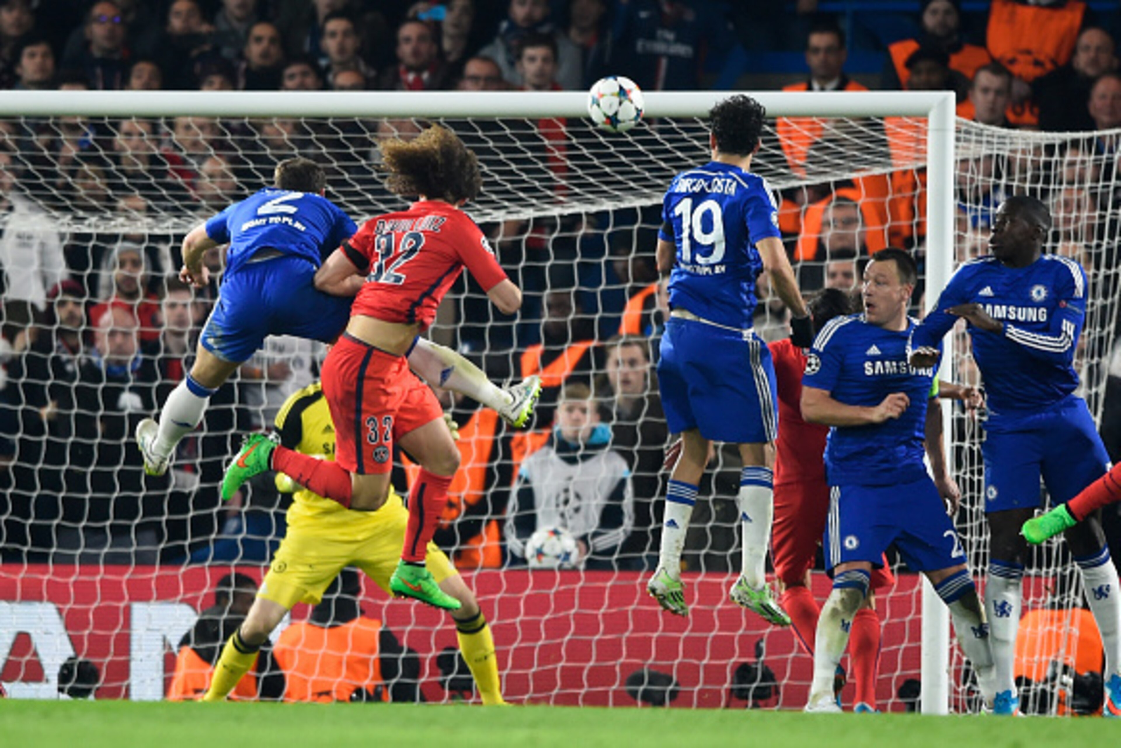LONDON, ENGLAND - MARCH 11:  David Luiz of PSG rises above Branislav Ivanovic of Chelsea to score a gol past goalkeeper Thibaut Courtois of Chelsea to level the scores at 1-1 during the UEFA Champions League Round of 16, second leg match between Chelsea a