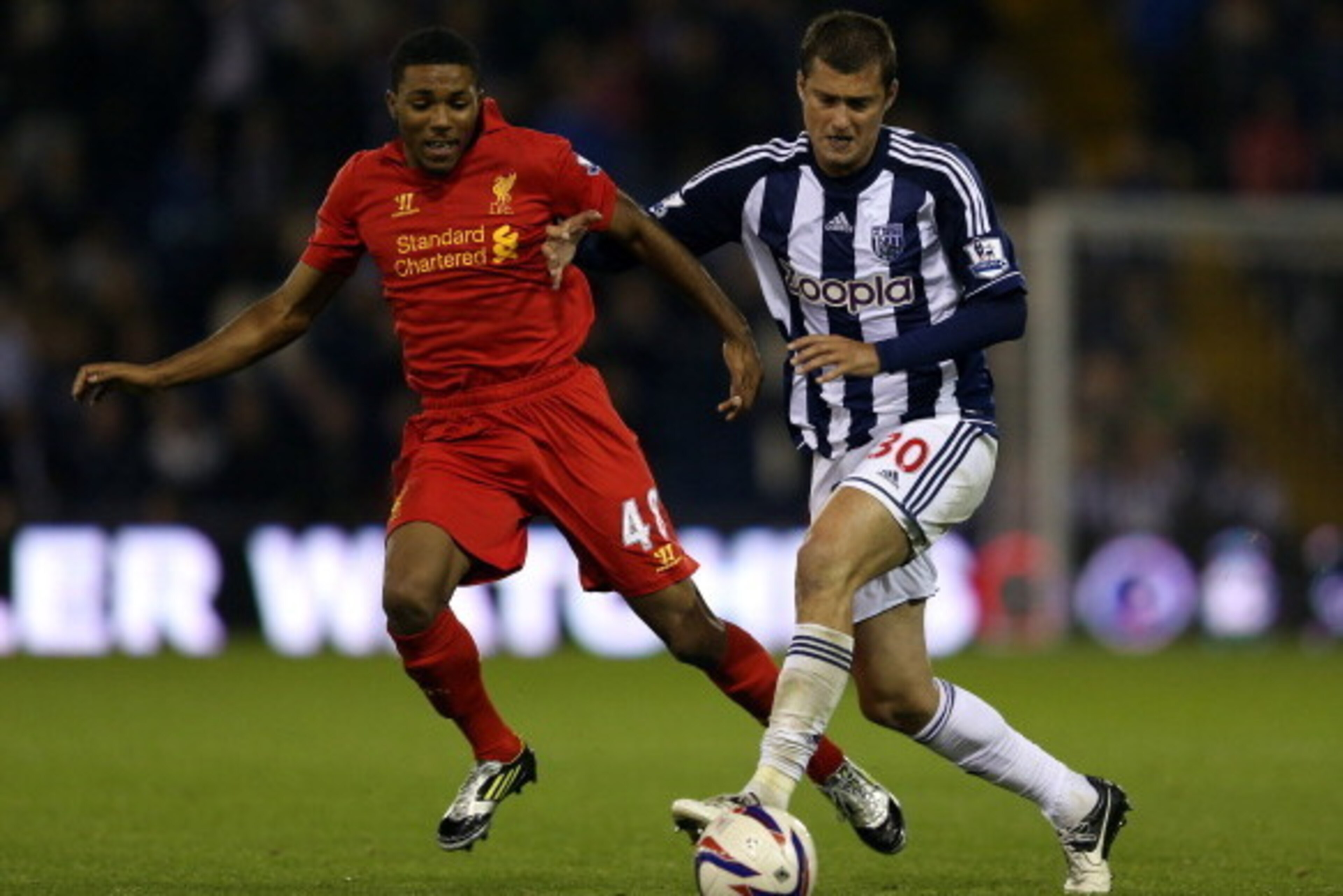 WEST BROMWICH, ENGLAND - SEPTEMBER 26:  Jerome Sinclair of Liverpool battles with Gabriel Tamas of West Brom during the Capital One Cup third round match between West Bromwich Albion and Liverpool at The Hawthorns on September 26, 2012 in West Bromwich, E