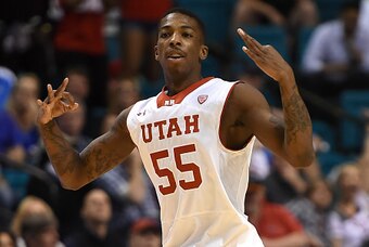 LAS VEGAS, NV - MARCH 12:  Delon Wright #55 of the Utah Utes holds up three fingers on each hand after hitting a 3-pointer against the Stanford Cardinal during a quarterfinal game of the Pac-12 Basketball Tournament at the MGM Grand Garden Arena on March 