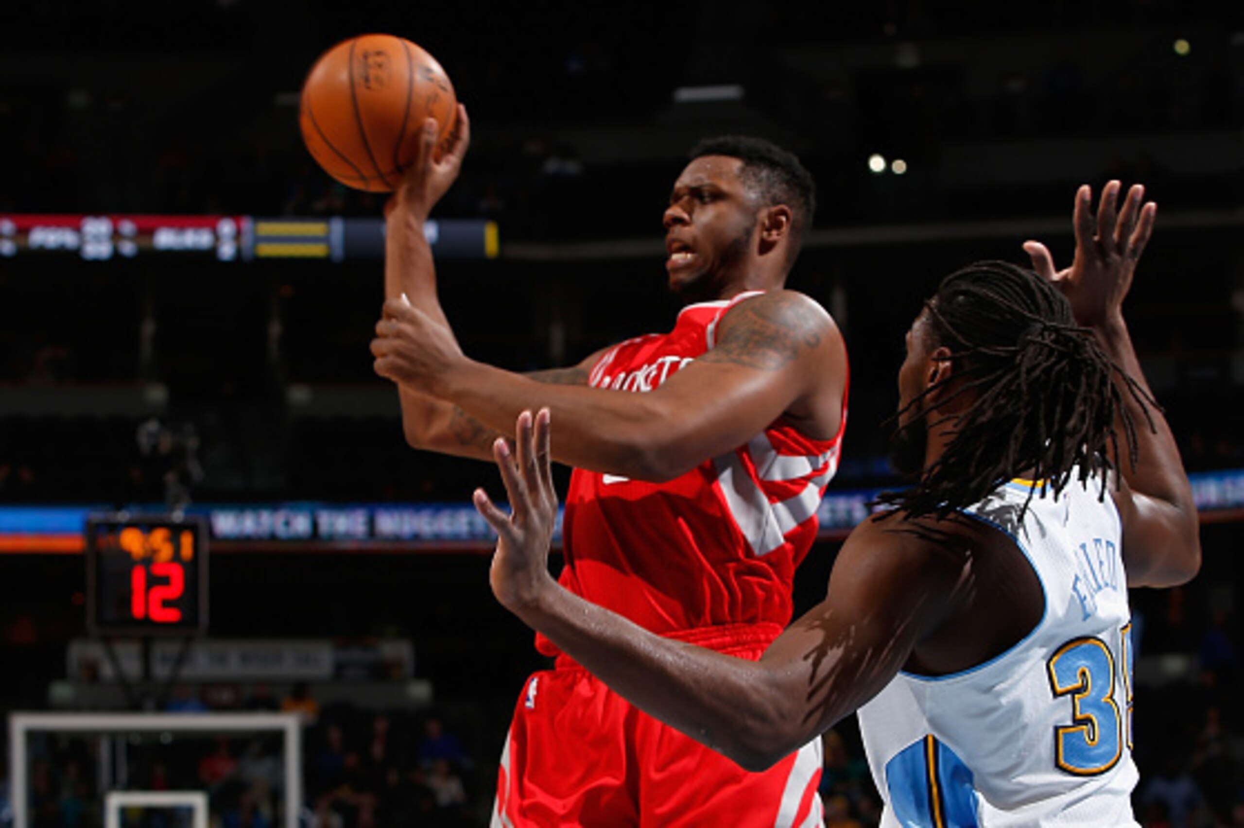 DENVER, CO - MARCH 07: Terrence Jones #6 of the Houston Rockets passes the ball against Kenneth Faried #35 of the Denver Nuggets at Pepsi Center on March 7, 2015 in Denver, Colorado. The Rockets defeated the Nuggets 114-100. NOTE TO USER: User expressly DENVER, CO - MARCH 07: Terrence Jones #6 of the Houston Rockets passes the ball against Kenneth Faried #35 of the Denver Nuggets at Pepsi Center on March 7, 2015 in Denver, Colorado. The Rockets defeated the Nuggets 114-100. NOTE TO USER: User expressly