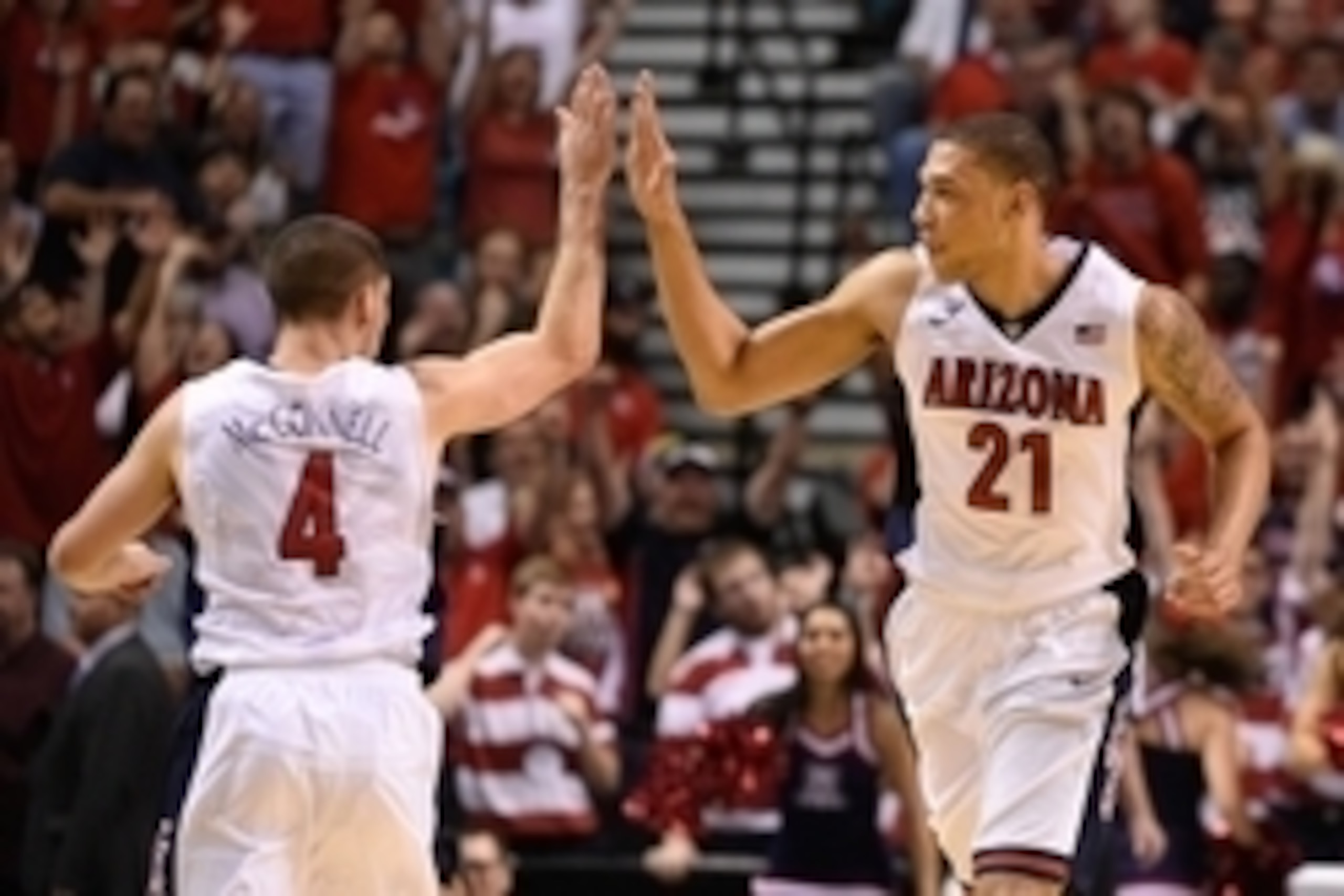 March 14, 2015; Las Vegas, NV, USA; Arizona Wildcats forward Brandon Ashley (21) celebrates with guard T.J. McConnell (4) during the second half in the championship game of the Pac-12 Conference tournament against the Oregon Ducks at MGM Grand Garden Aren