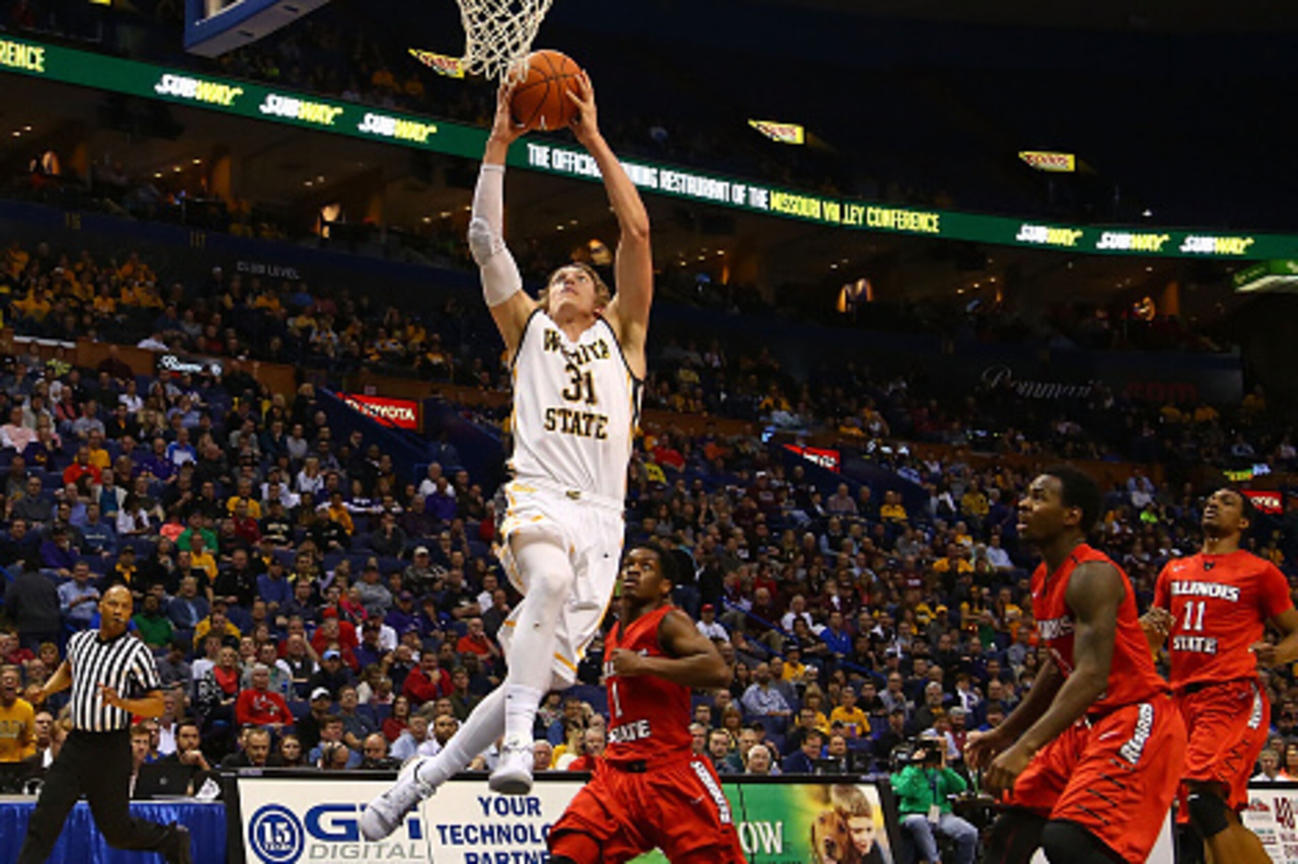 ST. LOUIS, MO - MARCH 7: Ron Baker #31 of the Wichita State Shockers goes for a lay up against Paris Lee #1, Daishon Knight #3 and MiKyle McIntosh #11 of the Illinois State Redbirds during the MVC Basketball Tournament Semifinals at the Scottrade Center o