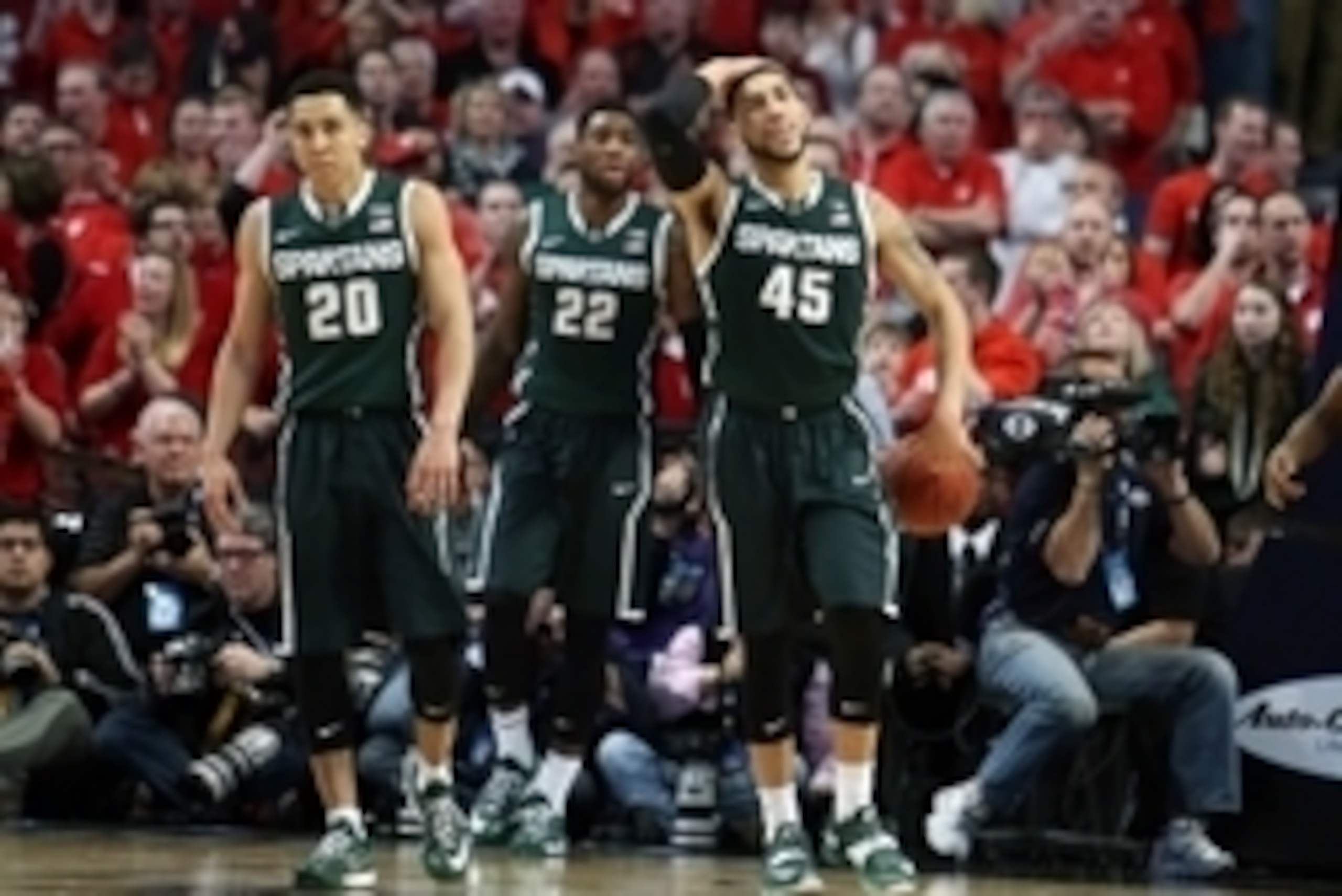 Mar 15, 2015; Chicago, IL, USA; Michigan State Spartans players Travis Trice (20) , Branden Dawson (22) and Denzel Valentine (45) react during the second half in the championship game of the Big Ten Tournament against the Wisconsin Badgers at United Cente
