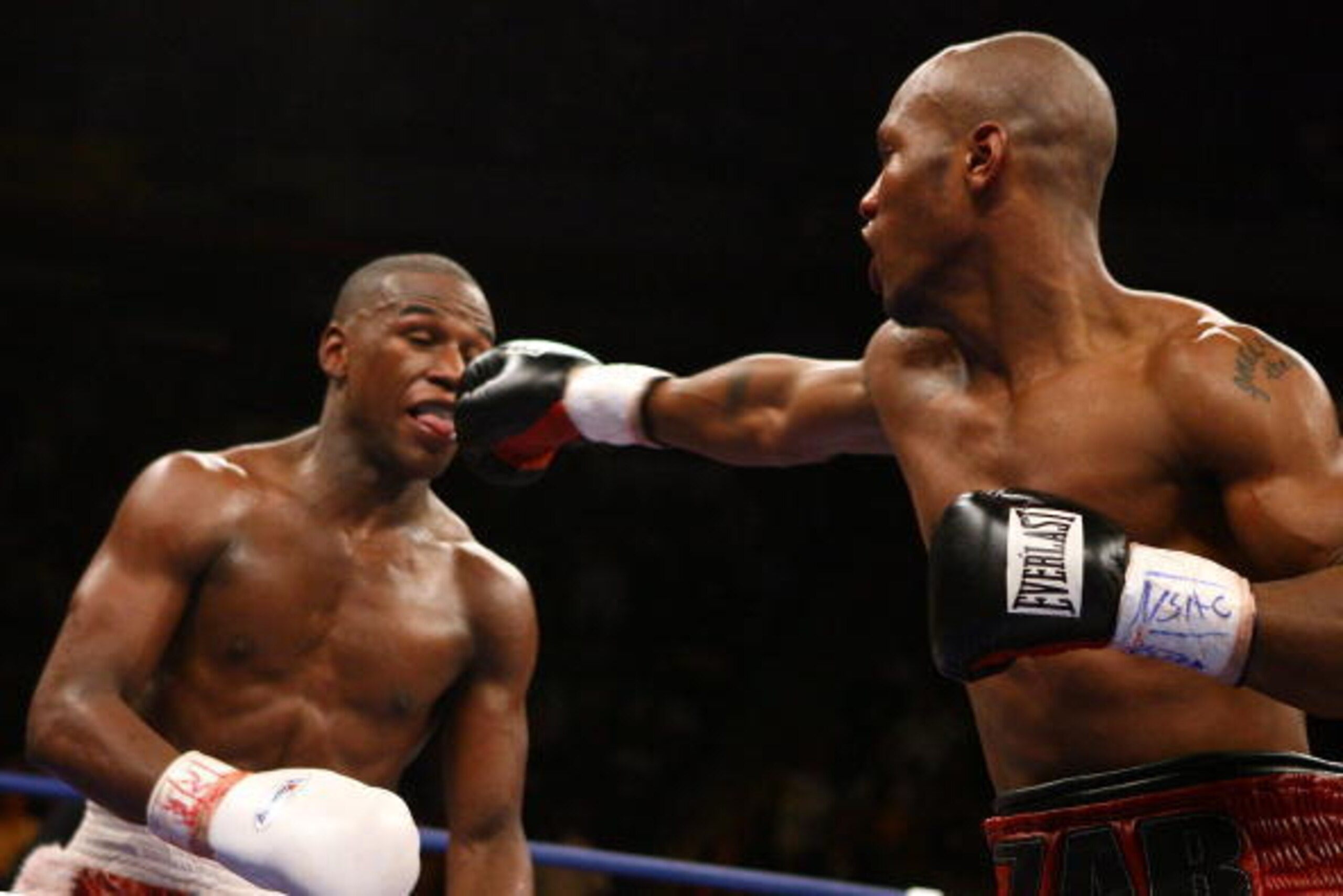 LAS VEGAS - APRIL 08: (L-R) Floyd Mayweather sticks his tounge out as Zab Judah tries to hit him in the mouth in the final round during the Welterweight Championship fight at Thomas & Mack Arena on April 8, 2006 in Las Vegas, Nevada. Mayweather was named 
