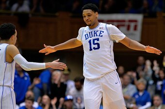 DURHAM, NC - FEBRUARY 04:  Jahlil Okafor #15 high-fives teammate Tyus Jones #5 of the Duke Blue Devils during a win against the Georgia Tech Yellow Jackets at Cameron Indoor Stadium on February 4, 2015 in Durham, North Carolina. Duke won 72-66.  (Photo by