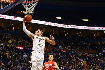ST. LOUIS, MO - MARCH 7: Ron Baker #31 of the Wichita State Shockers goes for a lay up against Justin McCloud #15 and Deontae Hawkins #23 of the Illinois State Redbirds during the MVC Basketball Tournament Semifinals at the Scottrade Center on March 7, 20